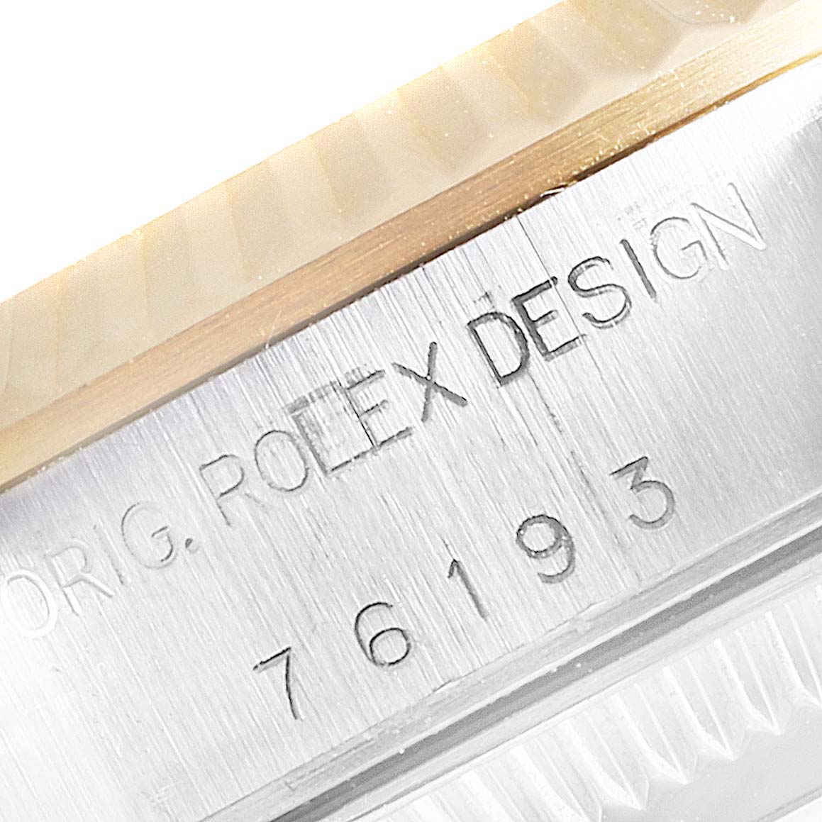 This image shows a close-up of the side of a Rolex Oyster Perpetual 76193 Women's Steel and Gold (two tone) Silver Dial 76193 Women's Steel and Gold (two tone) Silver Dial watch, highlighting the model number and "Rolex Design" engraving.