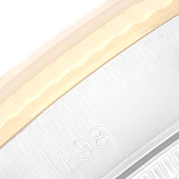 This close-up image shows the side and part of the case number engraved on the Rolex Oyster Perpetual 67193 Women's Steel and Gold (two tone) Champagne Dial 67193 Women's Steel and Gold (two tone) Champagne Dial watch.