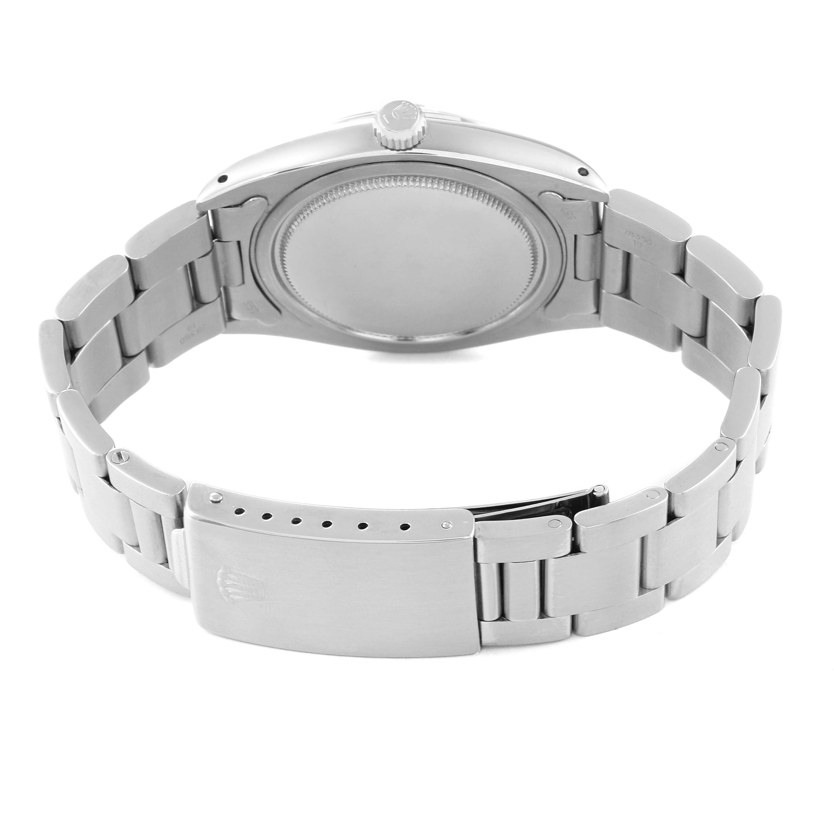 The image shows the back view of a Vintage Collection Rolex watch, displaying the case back and metal bracelet clasp.