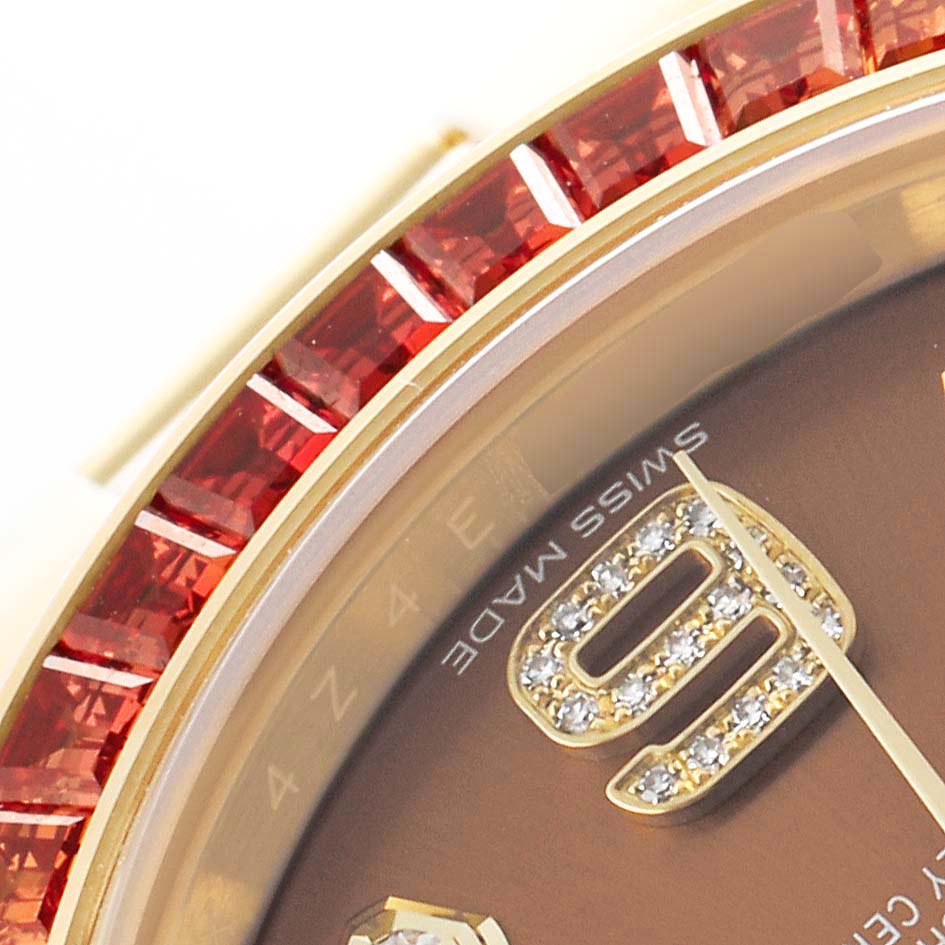 The image shows a close-up of the Rolex Pearlmaster 86348SAJOR Men's Yellow Gold Orange Dial watch bezel with red gemstones and part of the dial with diamond hour markers.