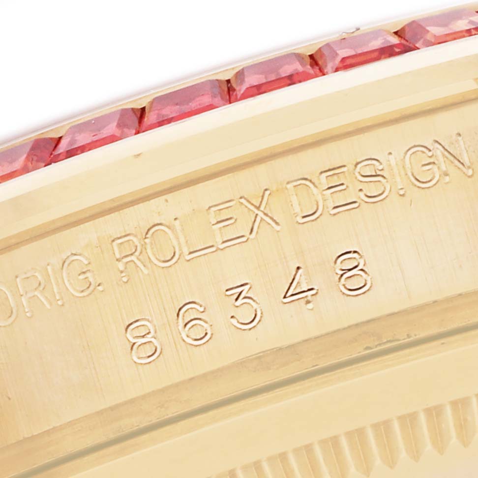 The image shows a close-up of the engraved case side and gemstone bezel of the Rolex Pearlmaster 86348SAJOR Men's Yellow Gold Orange Dial watch.