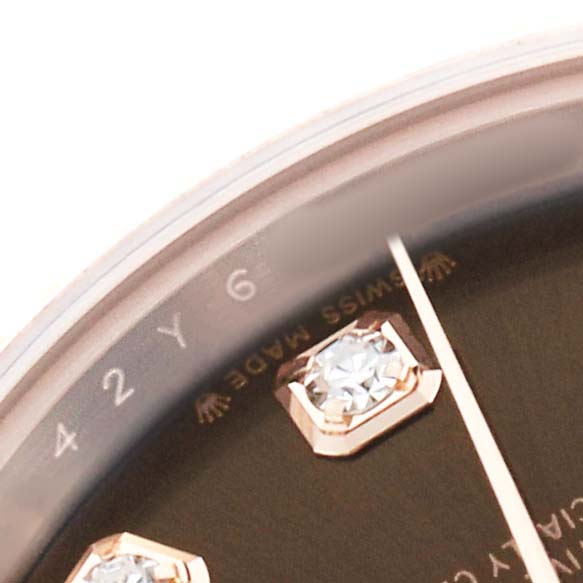 The image shows a close-up of the dial on a Rolex President 279175 Women's Rose Gold Brown Dial model, highlighting a diamond marker and "Swiss Made" near the edge.