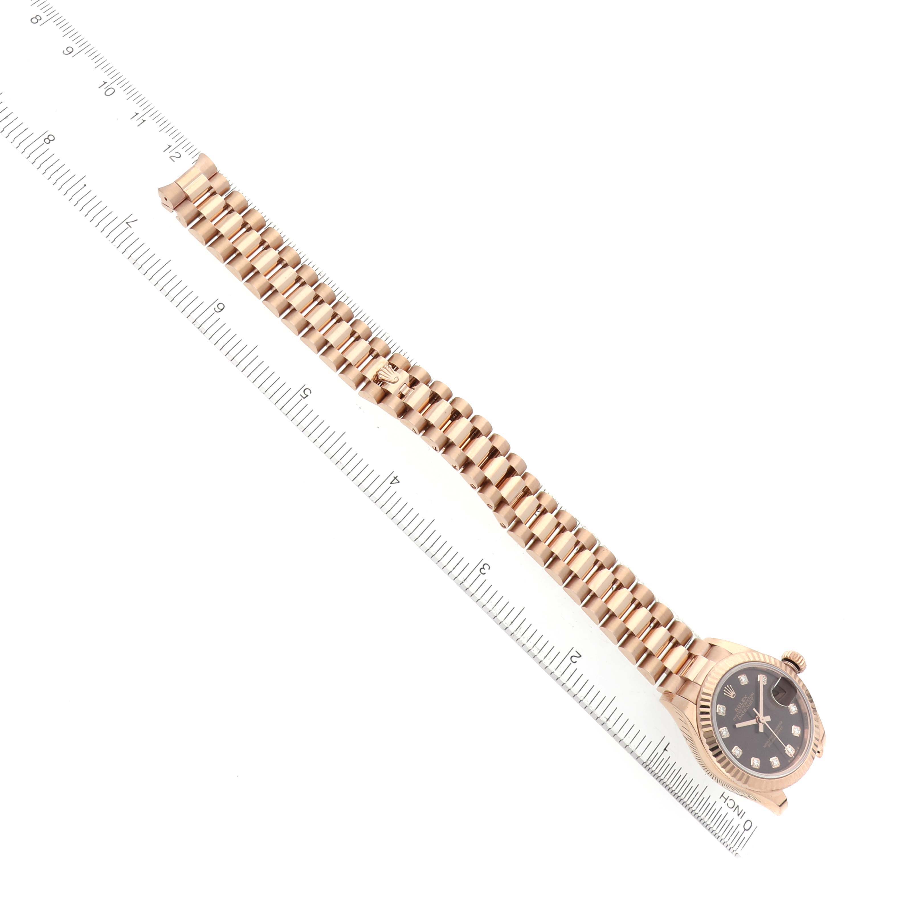 The image shows a Rolex President 279175 Women's Rose Gold Brown Dial watch at an angle, featuring its full bracelet and watch face next to a ruler for scale.