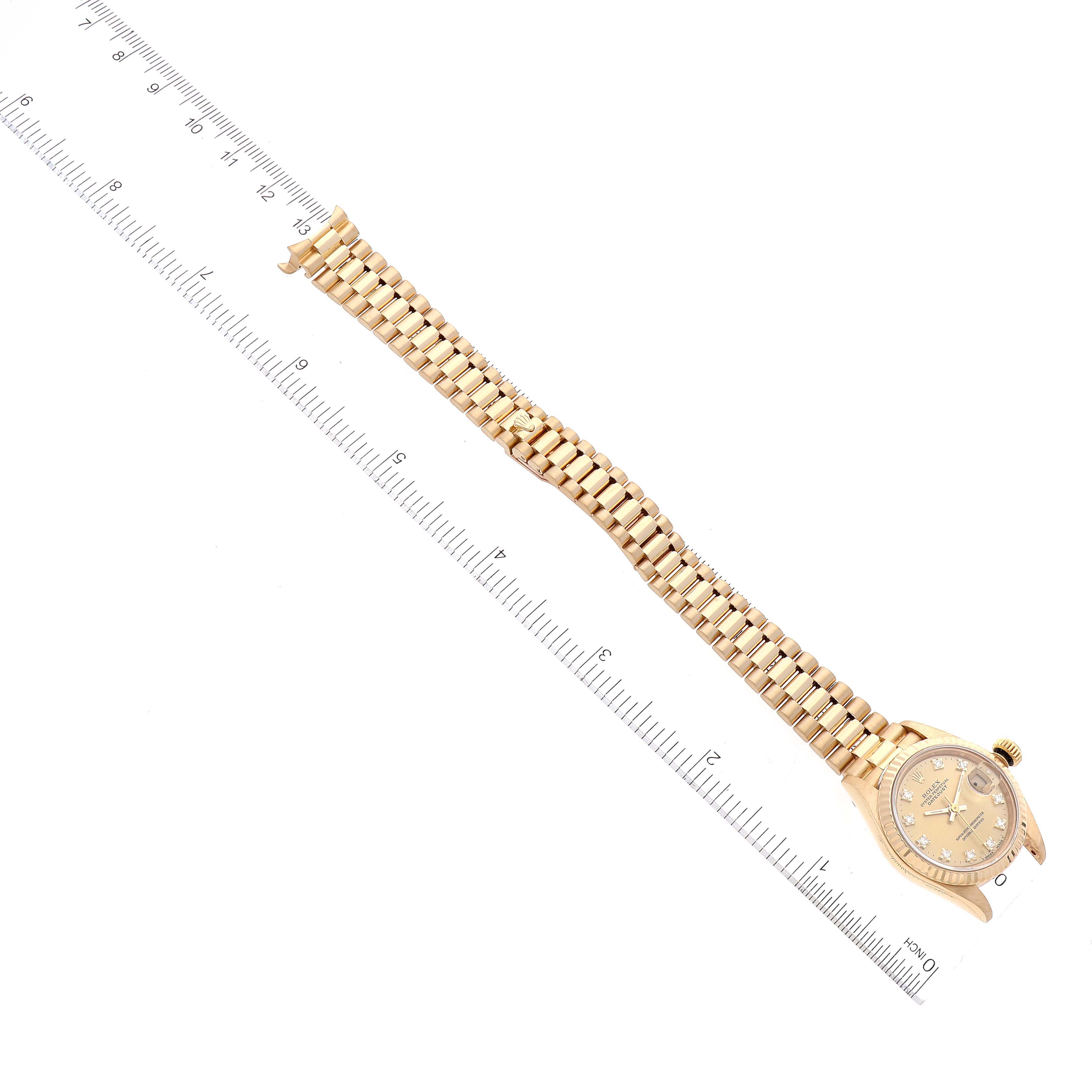This image shows a full view of a Rolex President 69178 Women's Yellow Gold Champagne Dial 69178 Women's Yellow Gold Champagne Dial model watch, including the face and bracelet, placed next to a ruler for size reference.