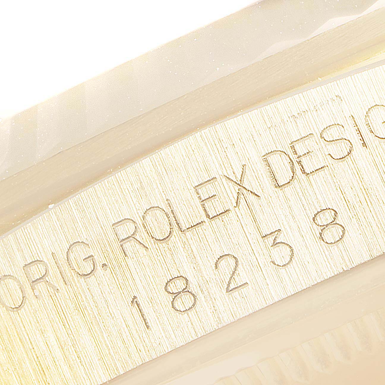 This close-up image shows the engraved model number and "Rolex Design" text on the case of a Rolex President 18238 Men
s Yellow Gold Champagne Dial 18238 Men
s Yellow Gold Champagne Dial model watch.