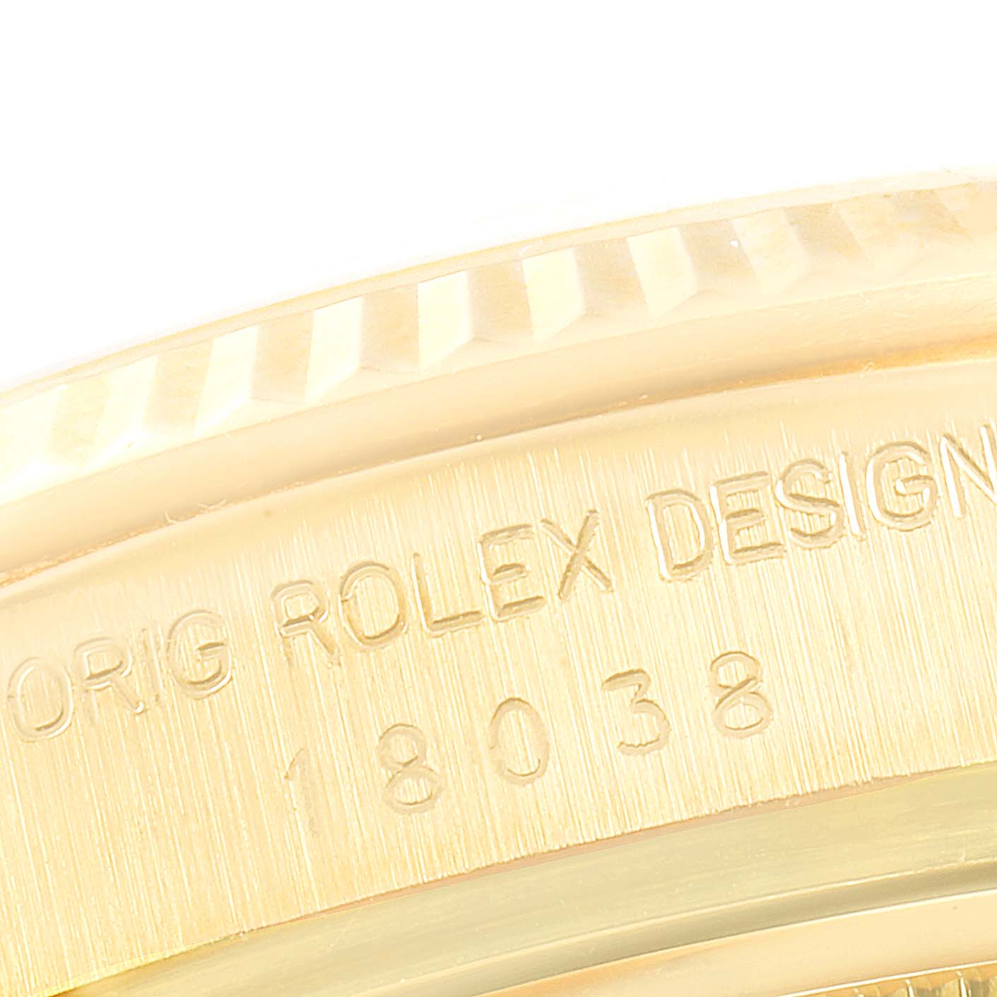This close-up image shows the engraved side of a Rolex President 18038 Men's Yellow Gold Champagne Dial 18038 Men's Yellow Gold Champagne Dial model with partial text and reference number 18038.