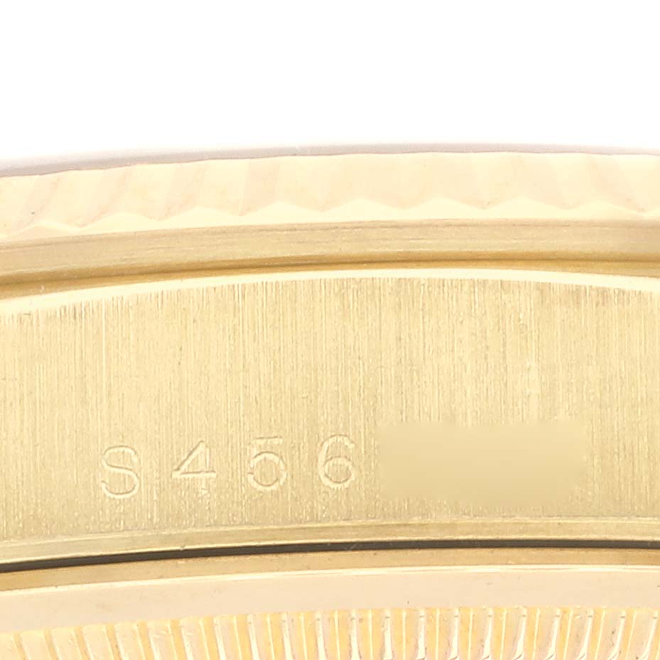 The image shows a close-up of the side of a Rolex President 18238 Men
s Yellow Gold Blue Dial 18238 Men
s Yellow Gold Blue Dial model watch, highlighting the serial number engraving.