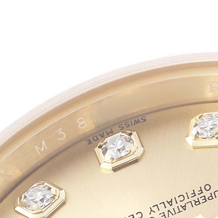 The image shows a close-up of a Rolex President 179238 Women's Yellow Gold Champagne Dial watch face, highlighting the gold bezel, diamond hour markers, and partial printing.