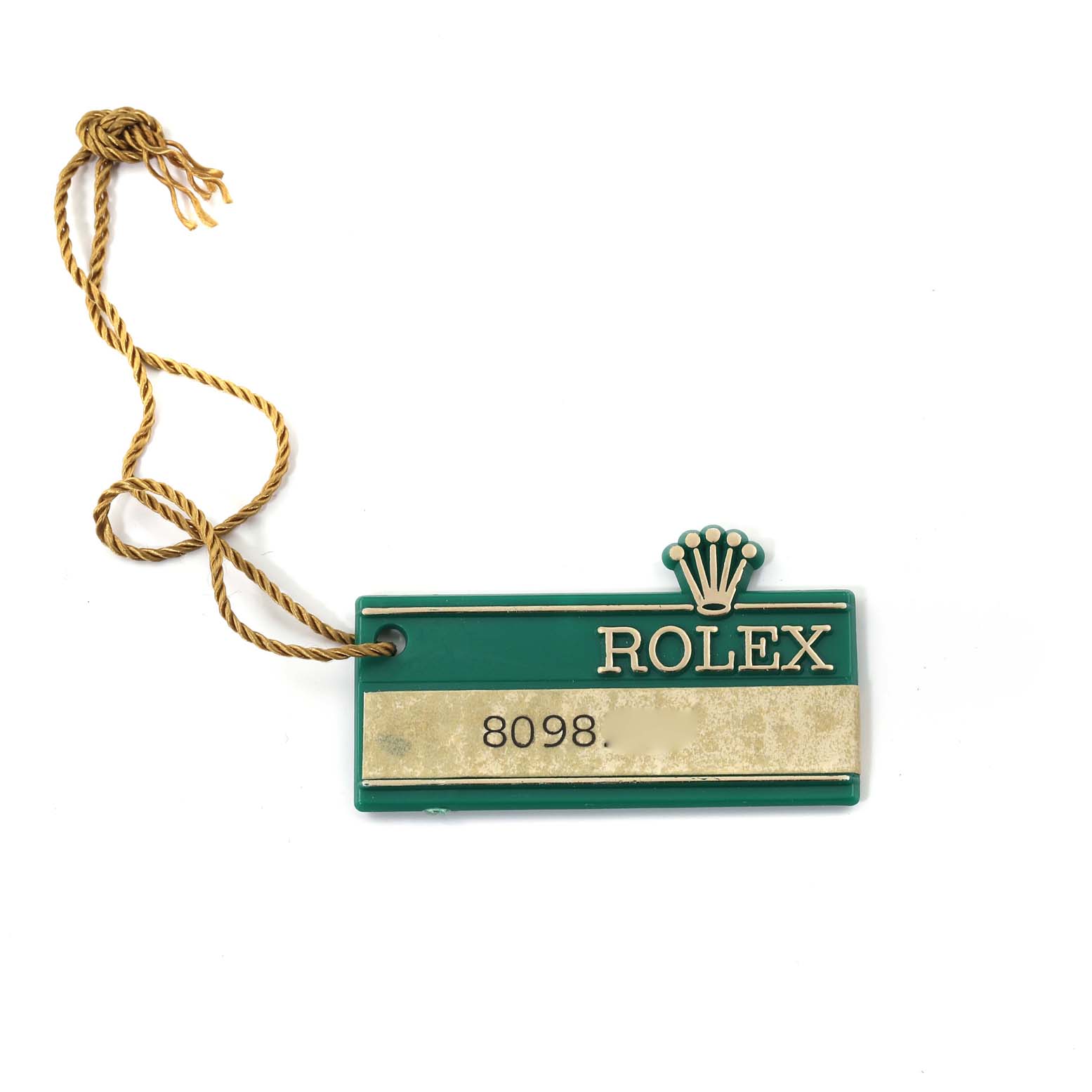 The image shows a green and gold Rolex tag for the Vintage Collection model, marked with the number 8098 and attached to a gold string.