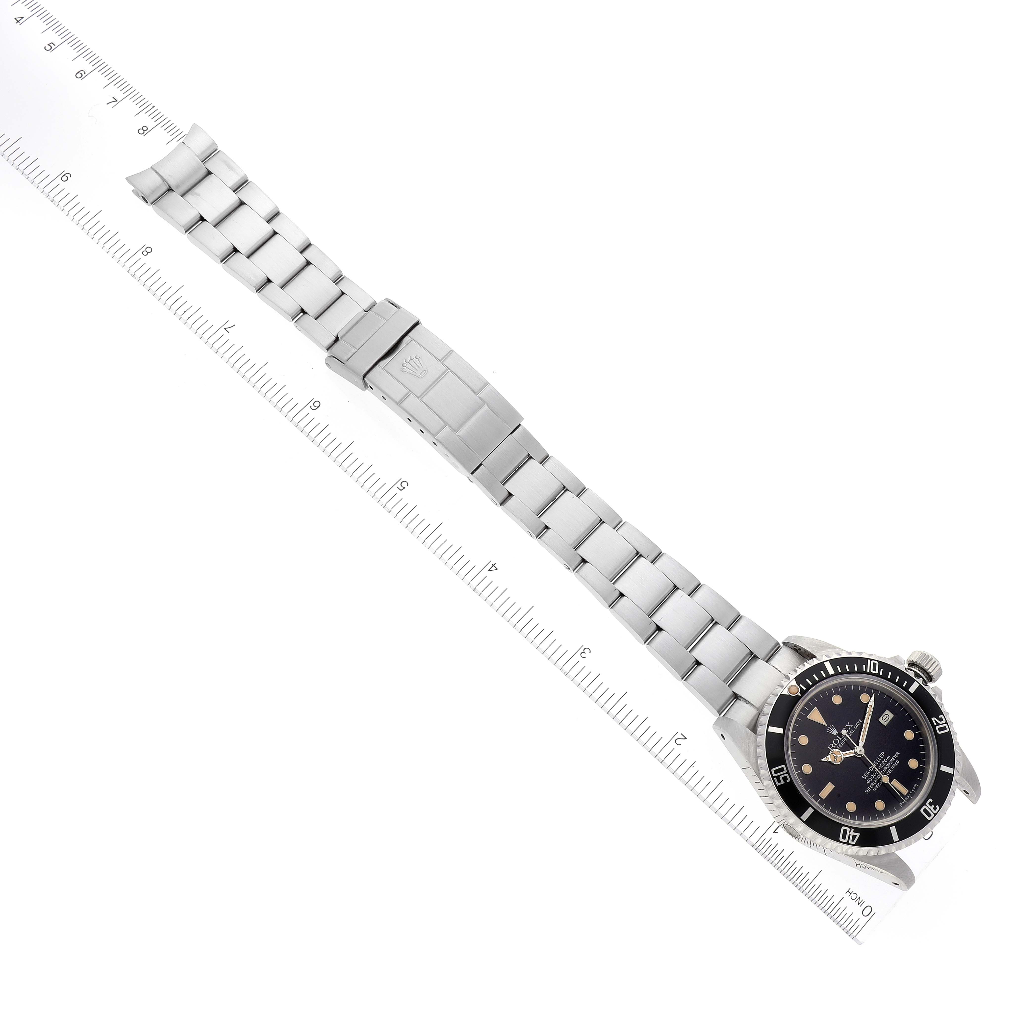 The image shows a Rolex Vintage Collection 16660 Men's Stainless Steel Black Dial 16660 Men's Stainless Steel Black Dial watch laid flat with its stainless steel bracelet and clasp fully visible, aligned along a ruler.