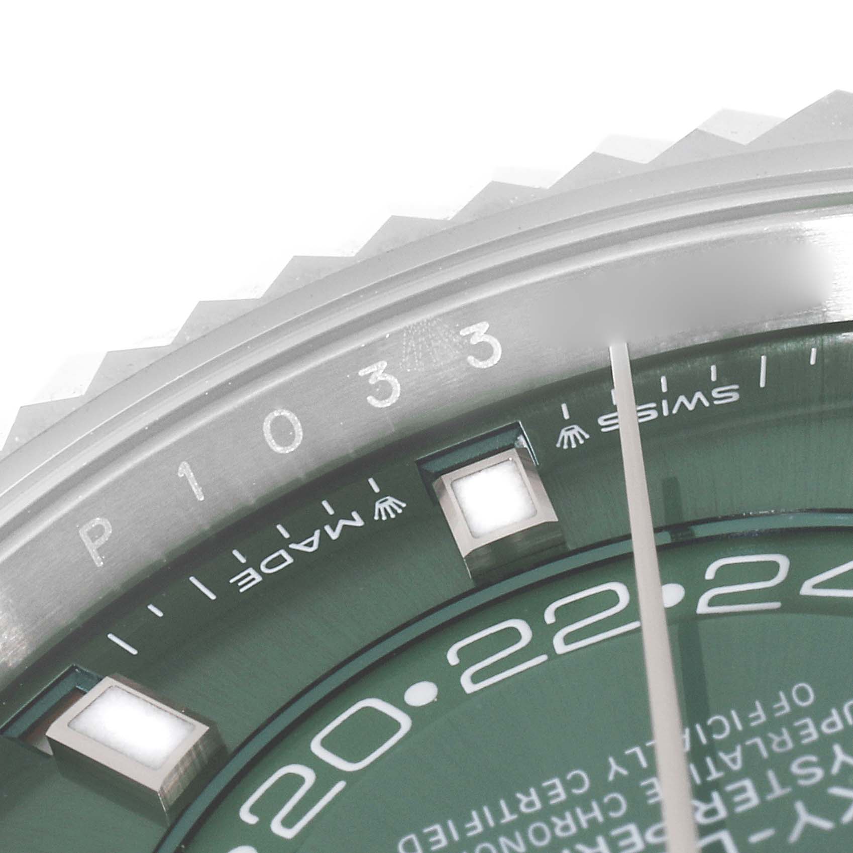 This image shows a close-up of the bezel and part of the dial of a Rolex Sky-Dweller 336934 Men
s Stainless Steel Green Dial 336934 Men
s Stainless Steel Green Dial watch, featuring the "SWISS MADE" inscription and hour markers.