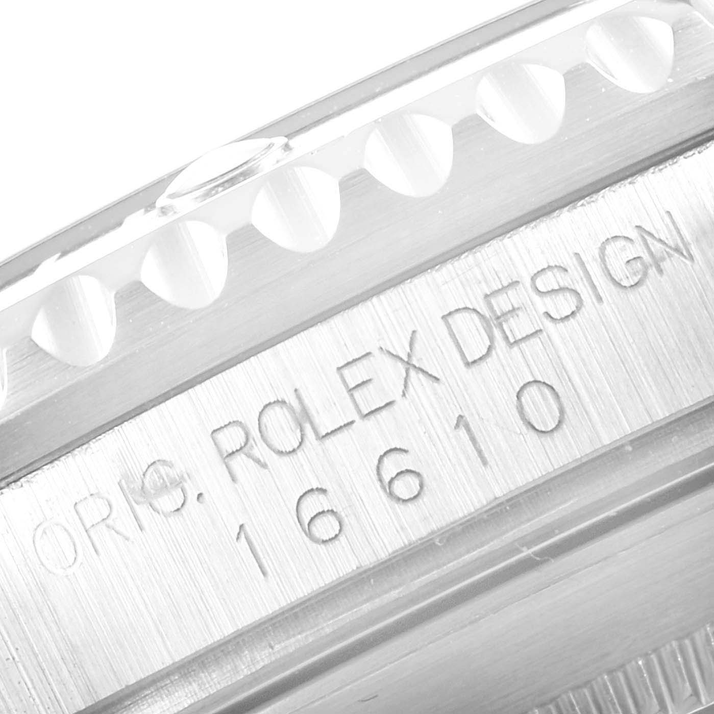 The image shows a close-up angle of the side of a Rolex Submariner 16610 Men
s Stainless Steel Black Dial 16610 Men
s Stainless Steel Black Dial watch, focusing on the engraved model and design number.