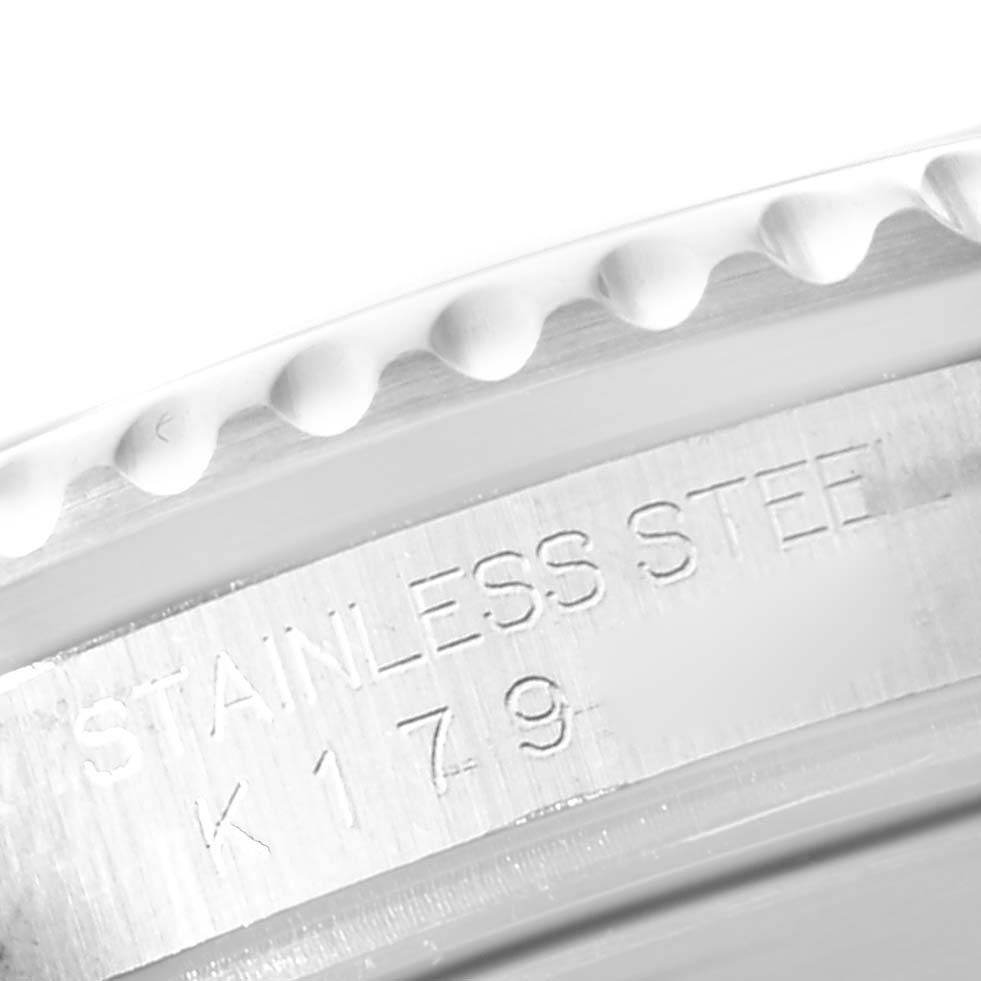 The image shows a close-up of the engraving on the side of the stainless steel bezel of a Rolex Submariner 16610 Men
s Stainless Steel Black Dial 16610 Men
s Stainless Steel Black Dial watch.
