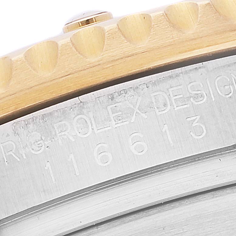 The image shows a close-up of the bezel and part of the case back of a Rolex Submariner 116613 Men's Steel and Gold (two tone) Black Dial 116613 Men's Steel and Gold (two tone) Black Dial watch.