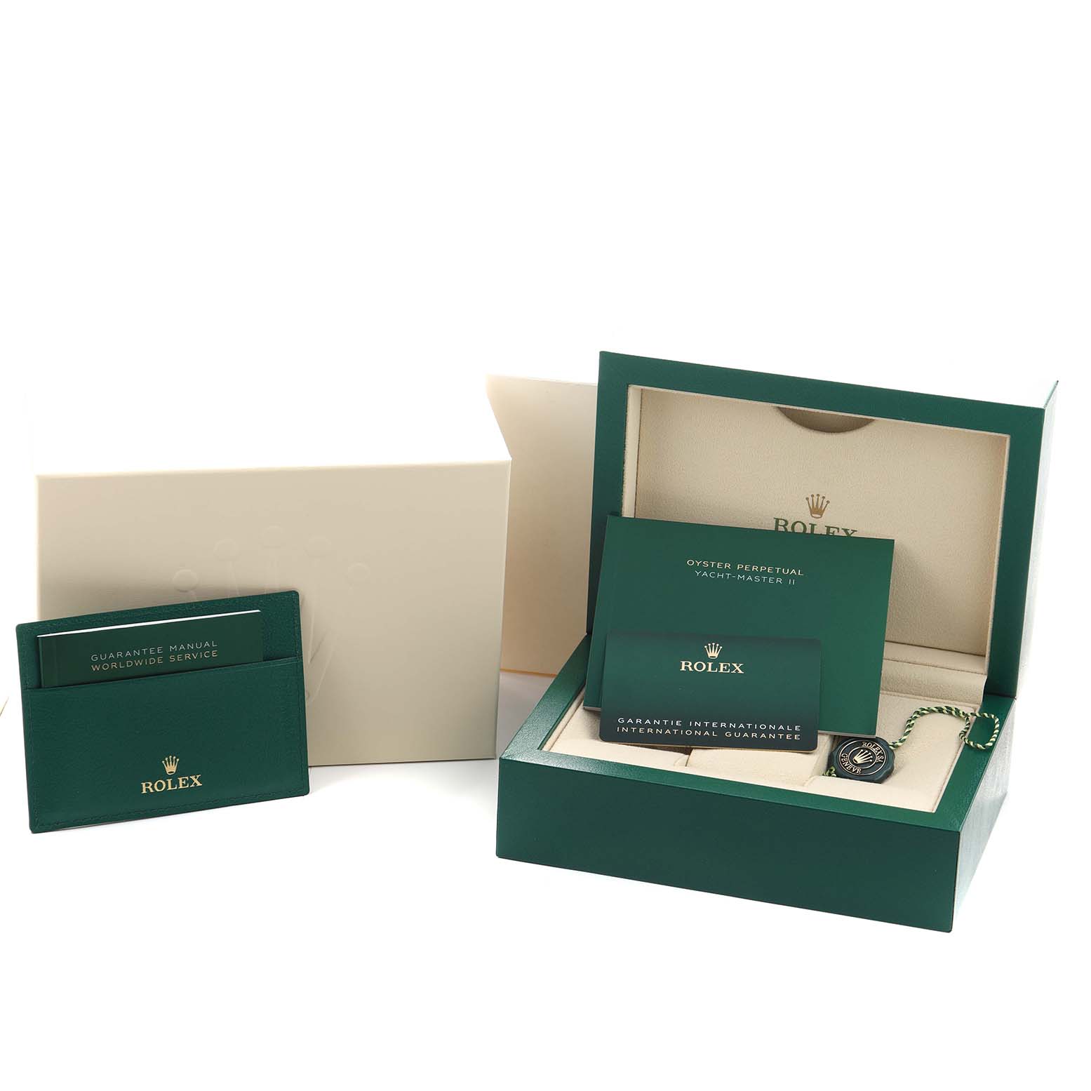 The image shows a Rolex Yacht-Master 116680 Men's Stainless Steel White Dial box, warranty card, manual, and a green tag, all at an angled view.