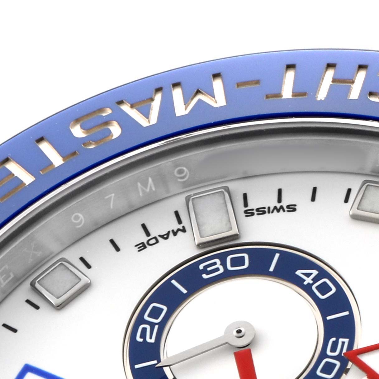 The image shows a close-up of the bezel and dial of a Rolex Yacht-Master 116680 Men's Stainless Steel White Dial, highlighting the blue bezel and part of the dial with hour markers.
