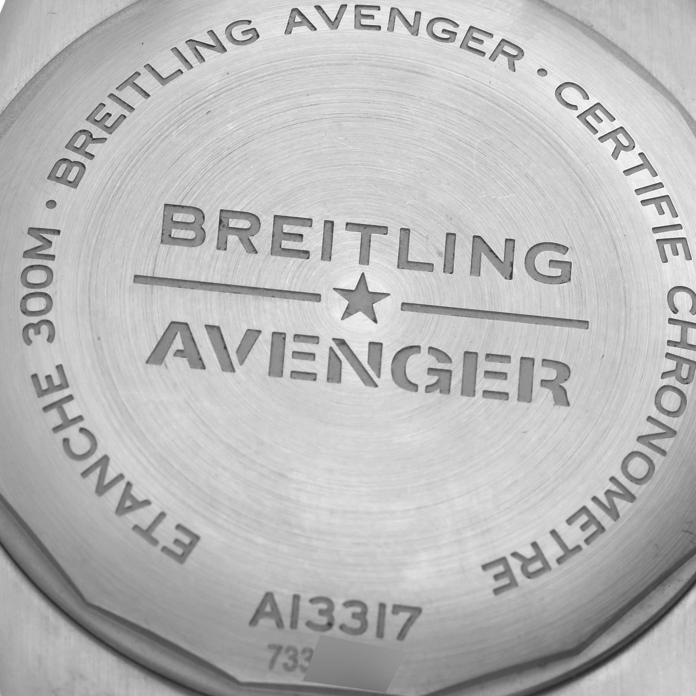 The image shows the back case of a Breitling Avenger A13317 Men's Stainless Steel Black Dial A13317 Men's Stainless Steel Black Dial watch, featuring engraved branding details and specifications.