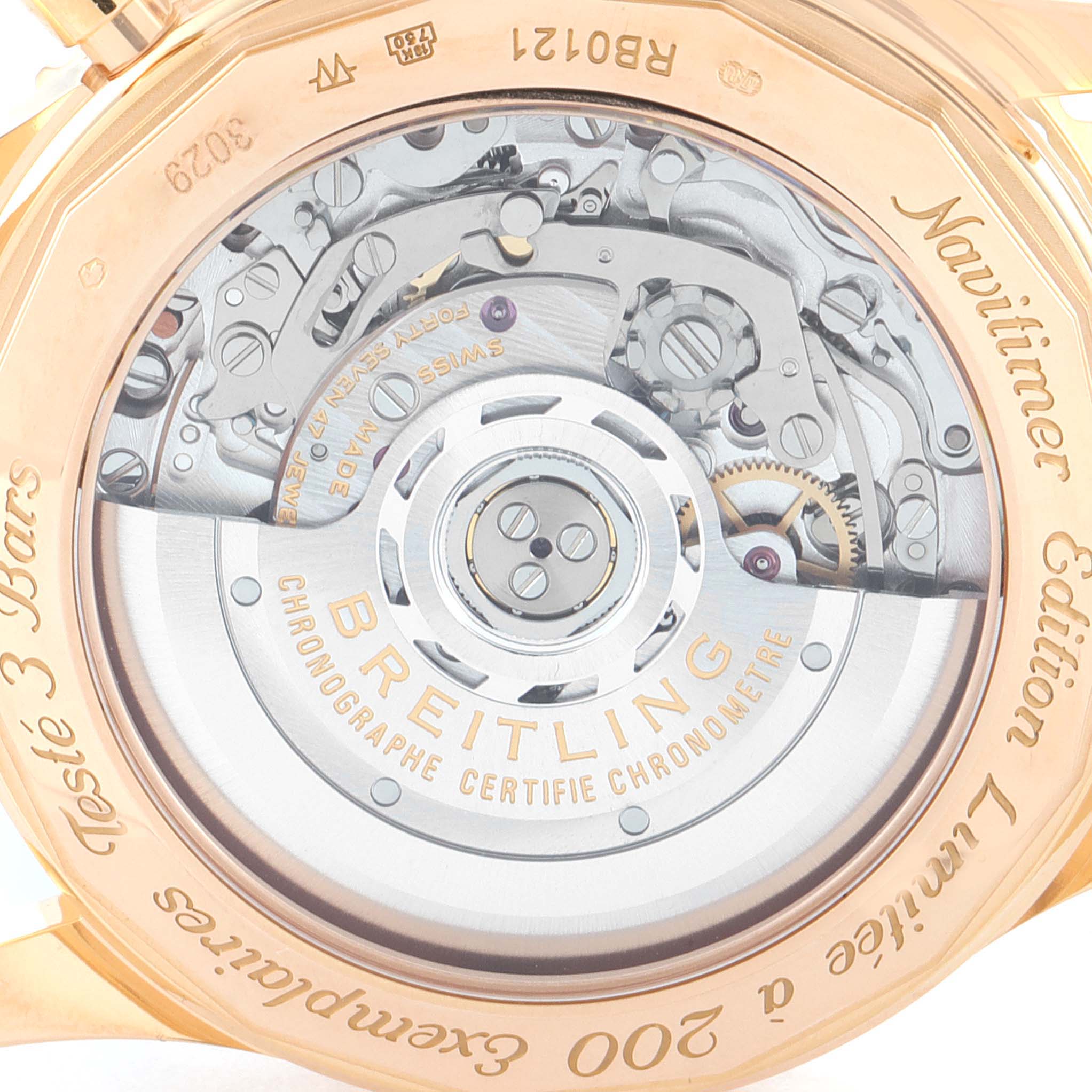 The image shows the back view of the Breitling Navitimer RB0121 Men's Rose Gold Black Dial RB0121 Men's Rose Gold Black Dial watch, highlighting its intricate movement and case engravings.