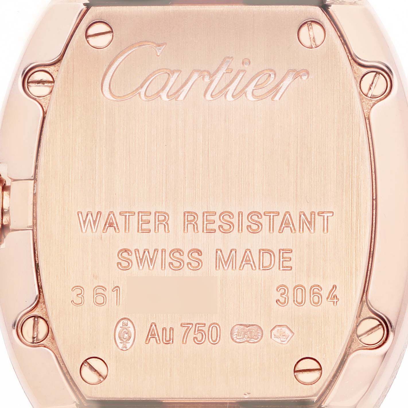 The image shows the back of a Cartier Baignoire W8000007 Women's Rose Gold Silver Dial watch, highlighting its engraving and screws.