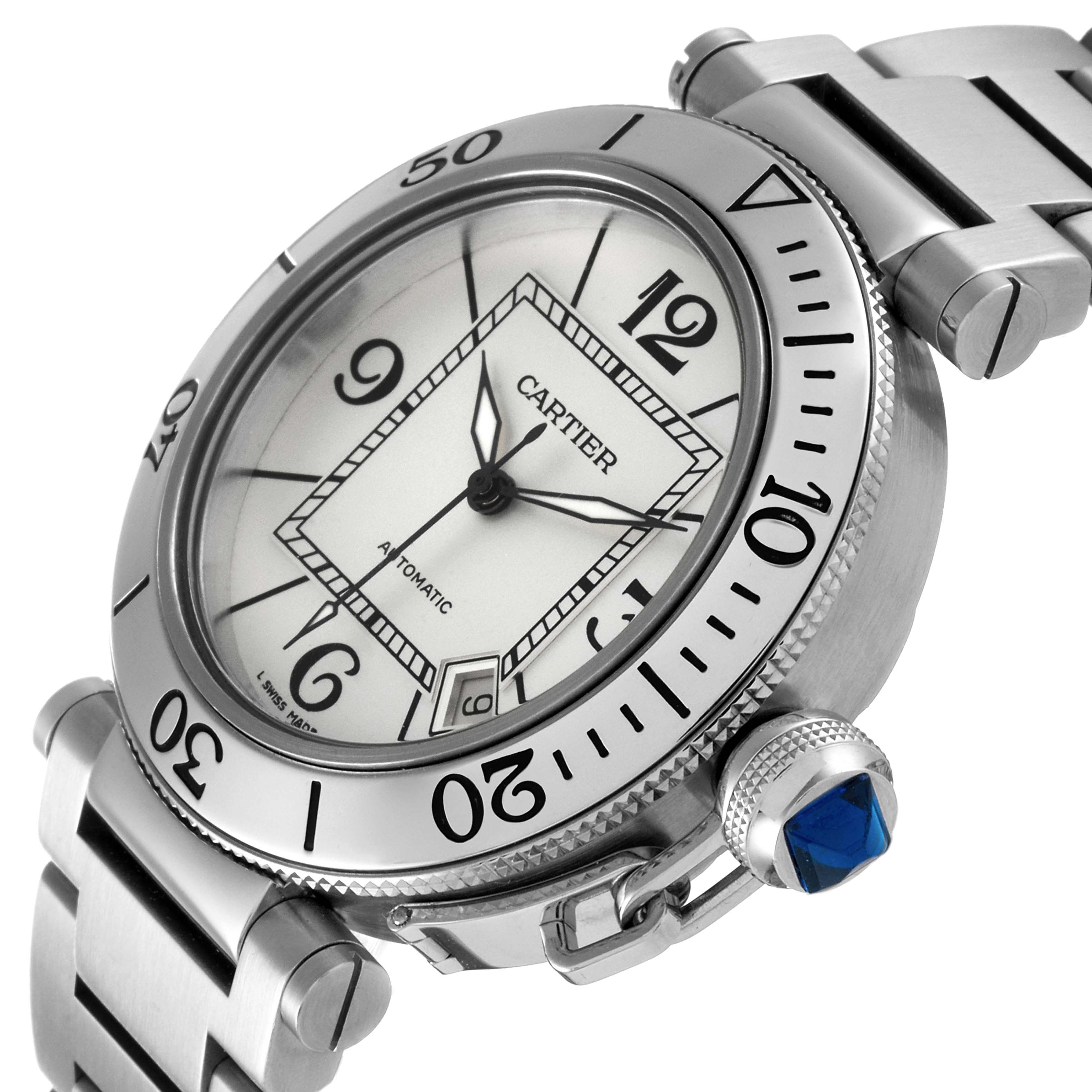 The image shows a close-up angle of the Cartier Pasha W31080M7 Men's Stainless Steel Silver Dial W31080M7 Men's Stainless Steel Silver Dial watch, highlighting the face, bezel, and a blue cabochon crown.