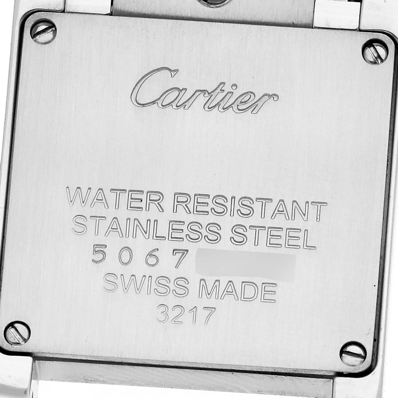 The image shows the back of a Cartier Tank Française watch, highlighting engravings such as "water resistant" and "stainless steel."