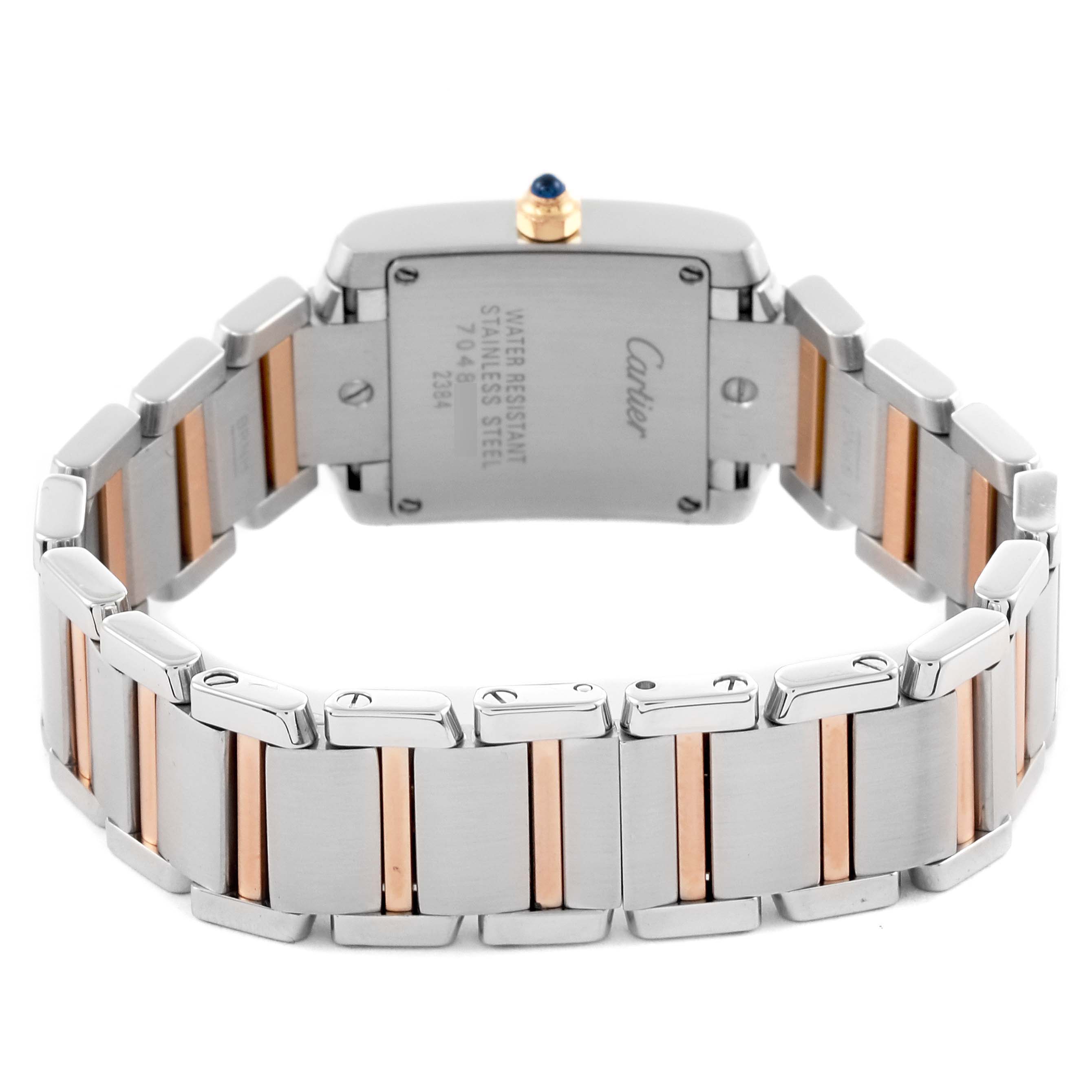 The Cartier Tank Française watch is shown from the back, highlighting the case back and stainless steel bracelet with gold accents.