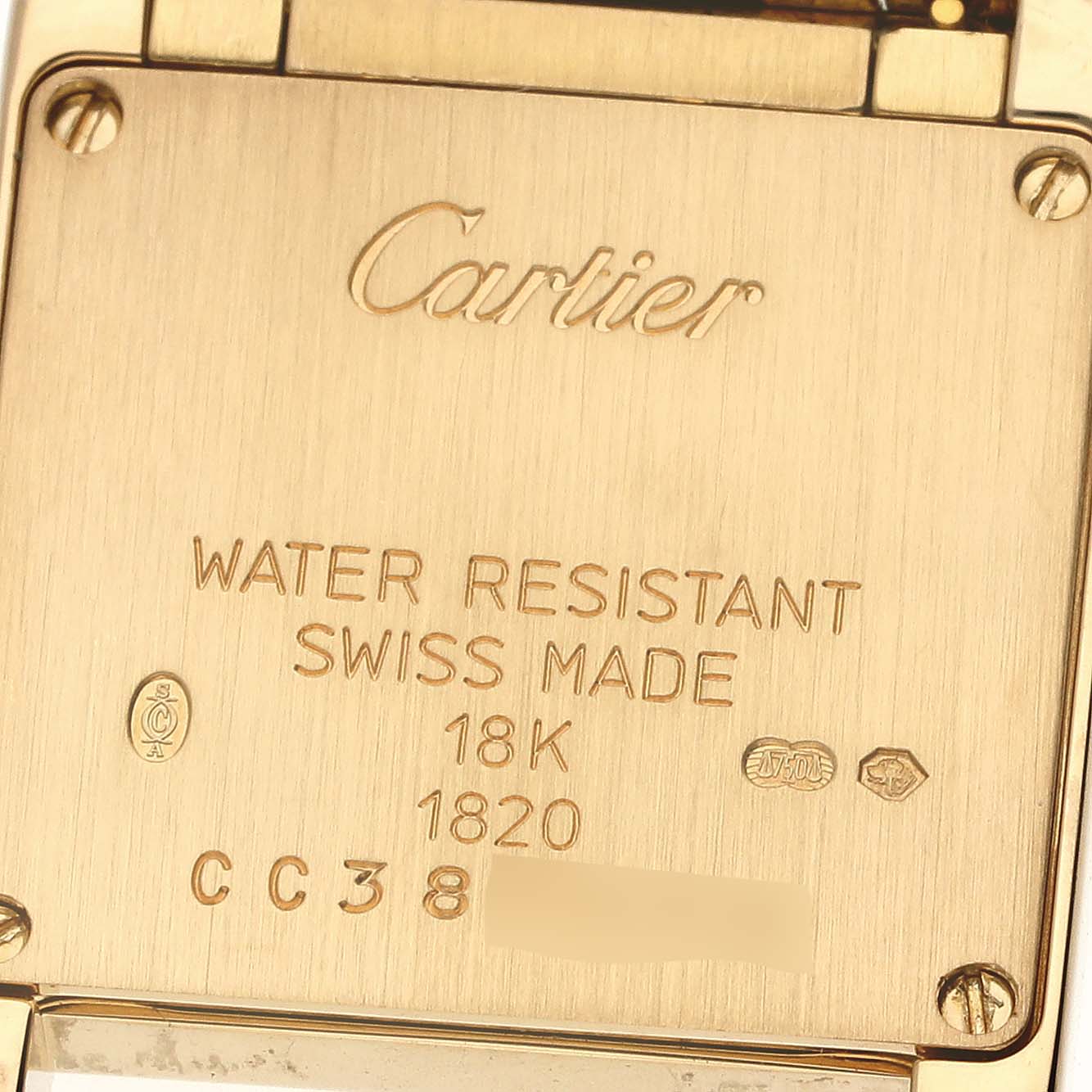 The image shows the back case of a Cartier Tank Française watch, displaying inscriptions and material details.