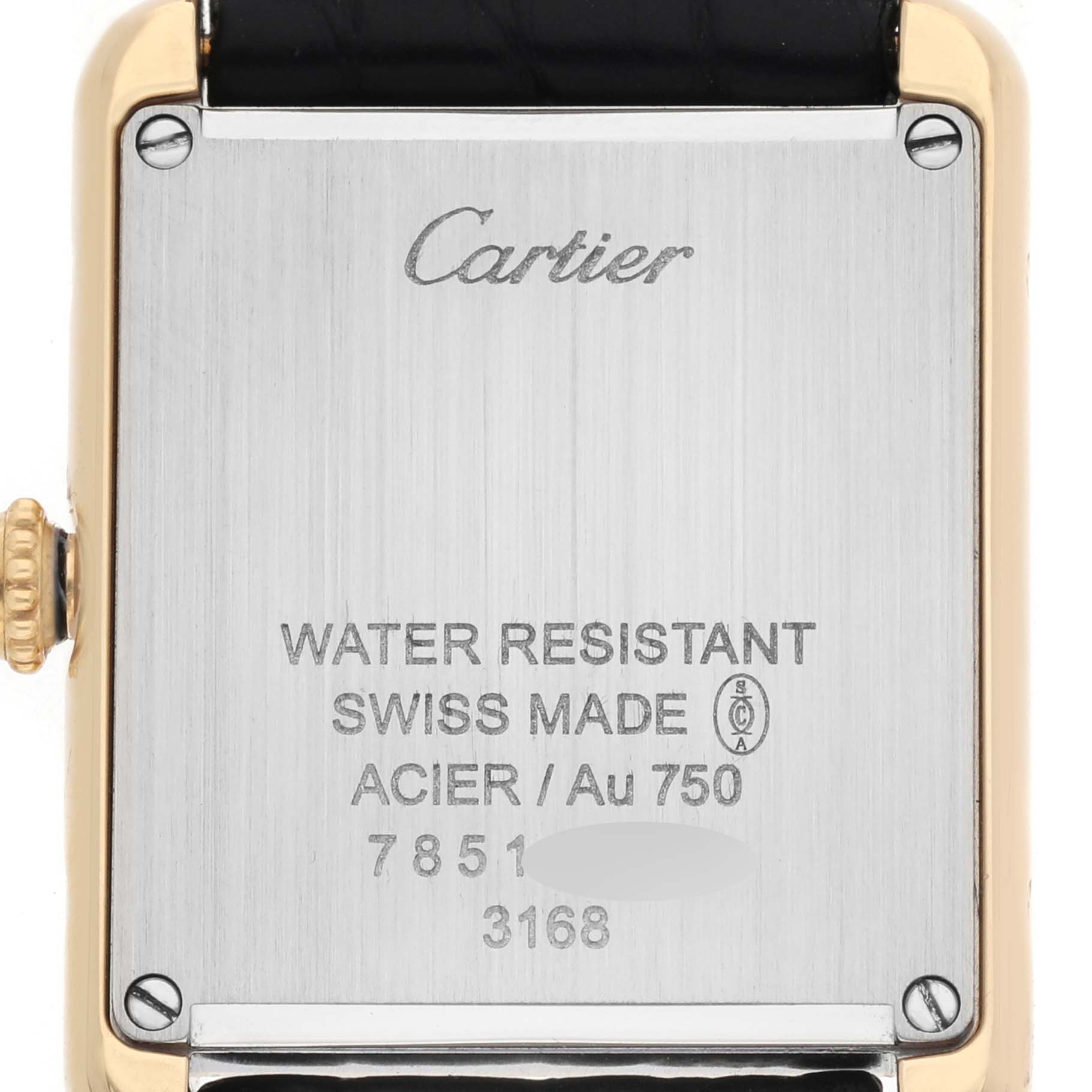 The image shows the back of a Cartier Tank Solo W5200002 Women's Yellow Gold Silver Dial watch, displaying its inscriptions and screws.