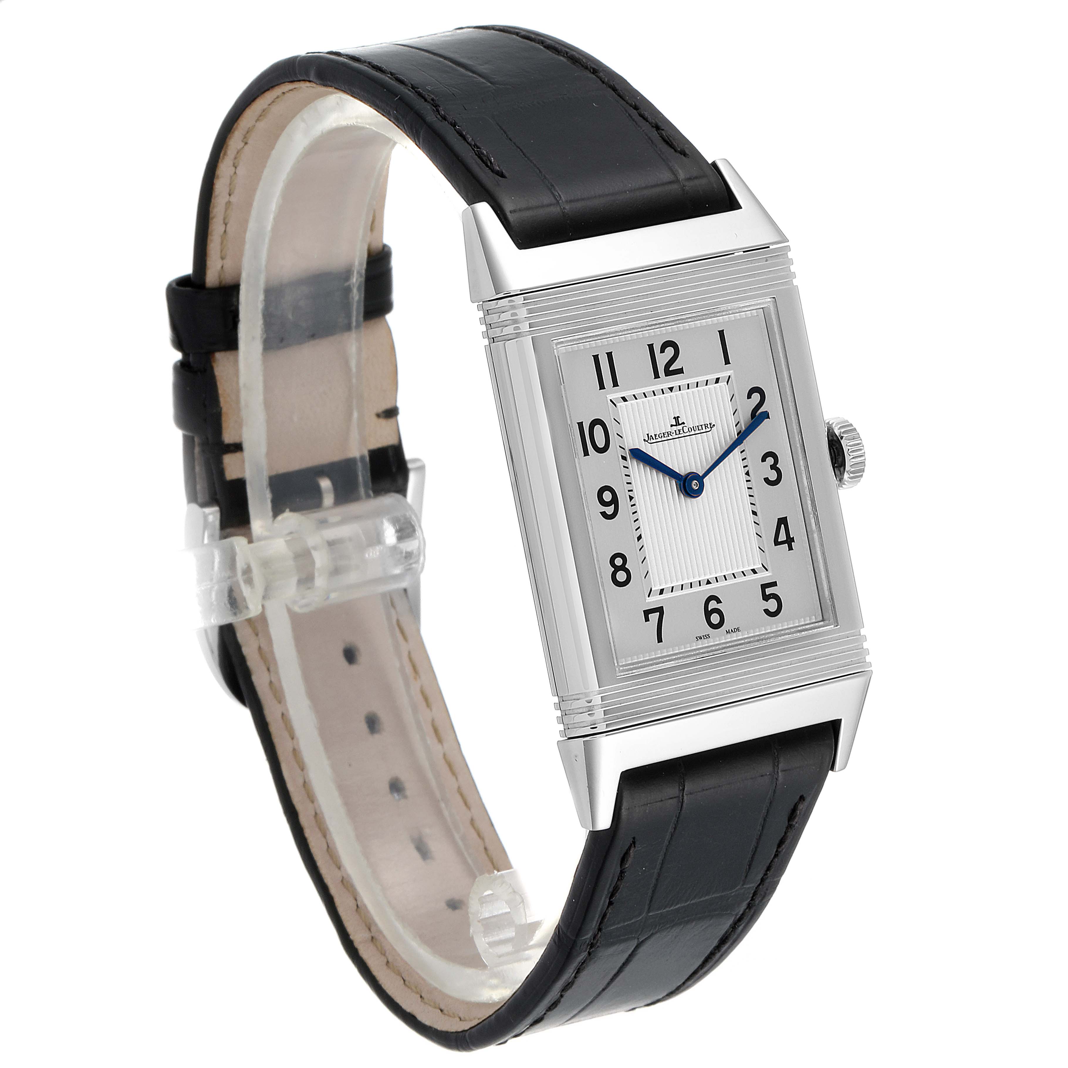The Jaeger-LeCoultre Reverso watch is shown at a slight angle displaying its rectangular dial and black leather strap.