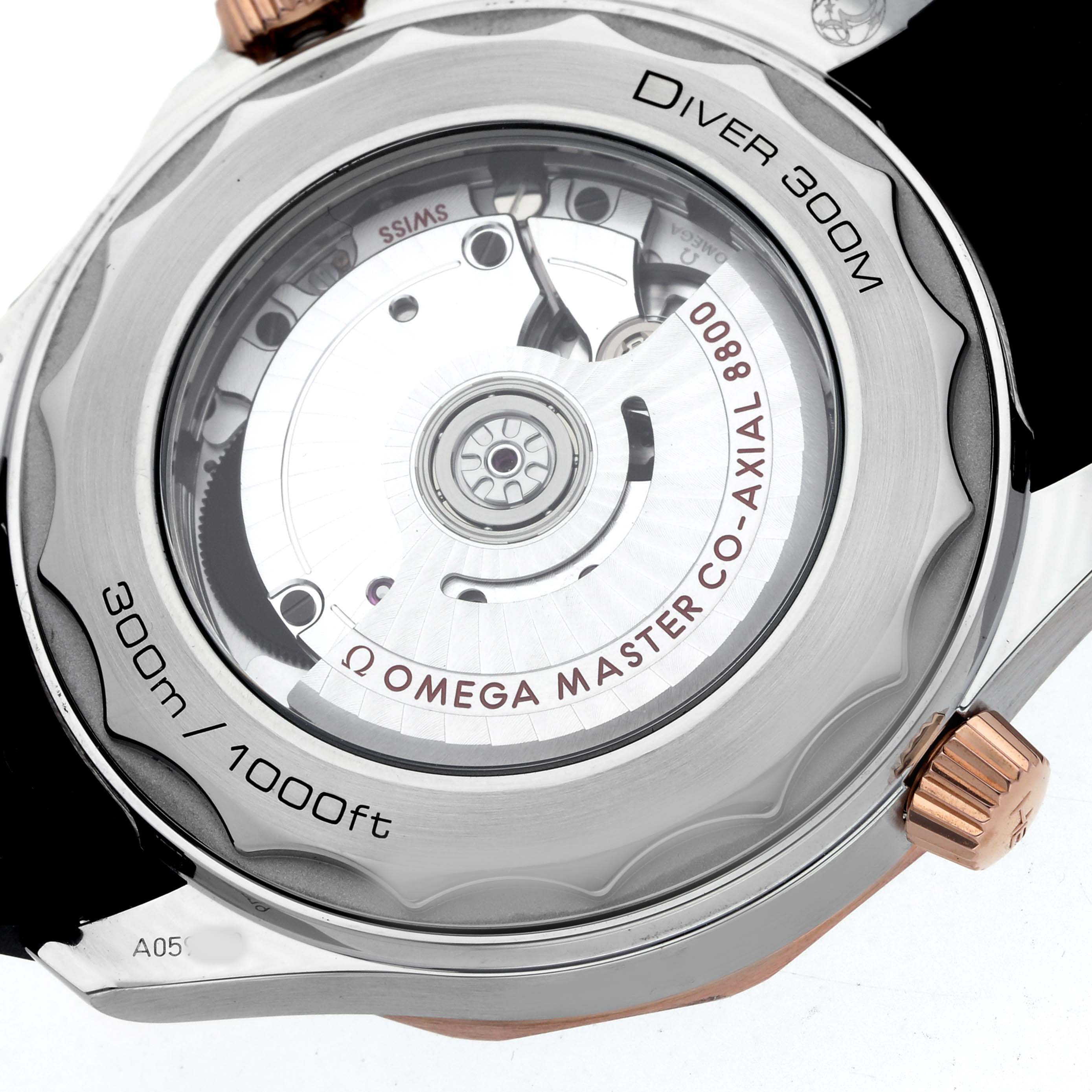 The image shows a close-up view of the Omega Seamaster 210.22.42.20.01.002 Men's Steel and Gold (two tone) Black Dial's transparent case back, revealing its movement.