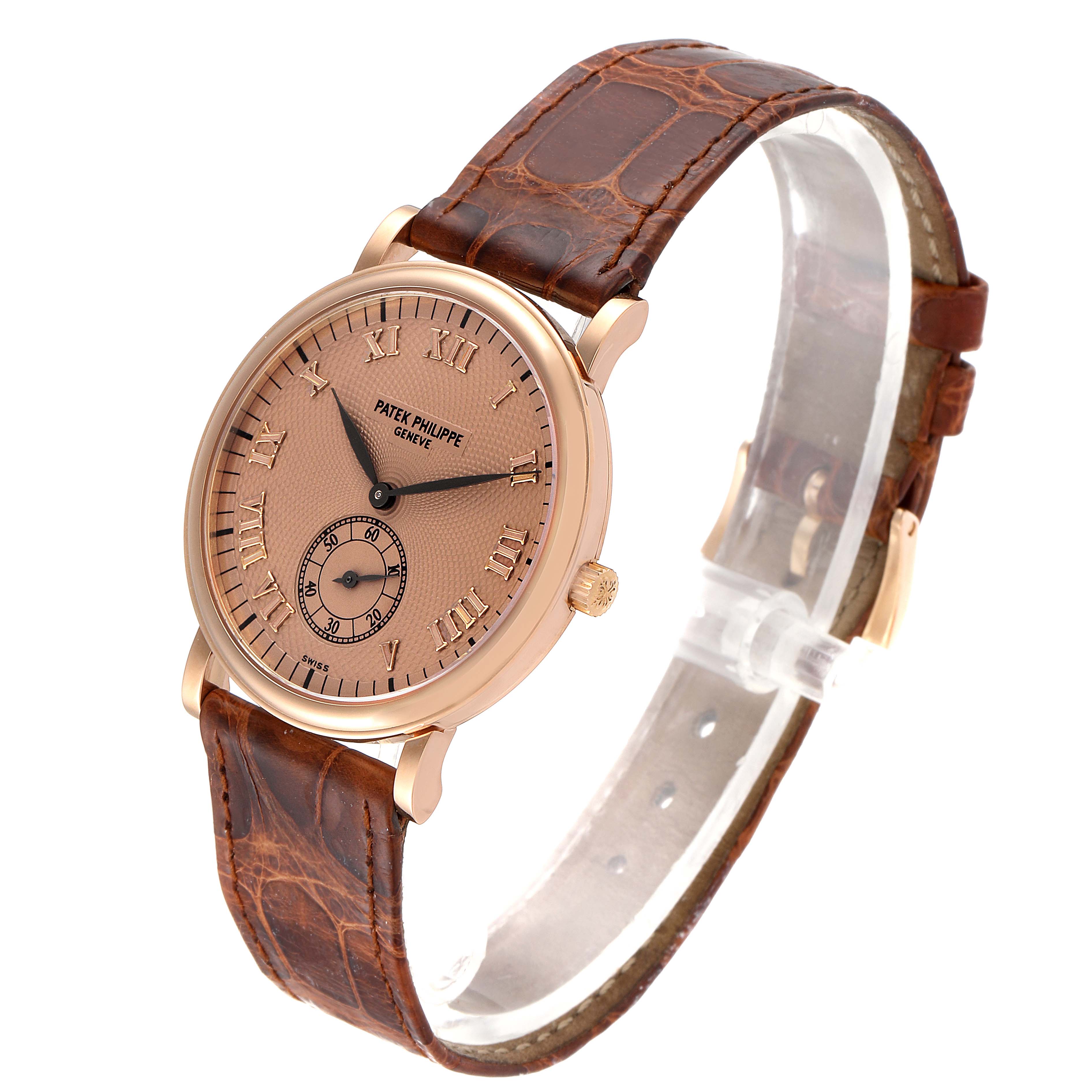 The Patek Philippe Calatrava 5022R Men's Rose Gold Pink Dial 5022R Men's Rose Gold Pink Dial watch is shown at a 3/4 angle, showcasing the dial, strap, and crown.