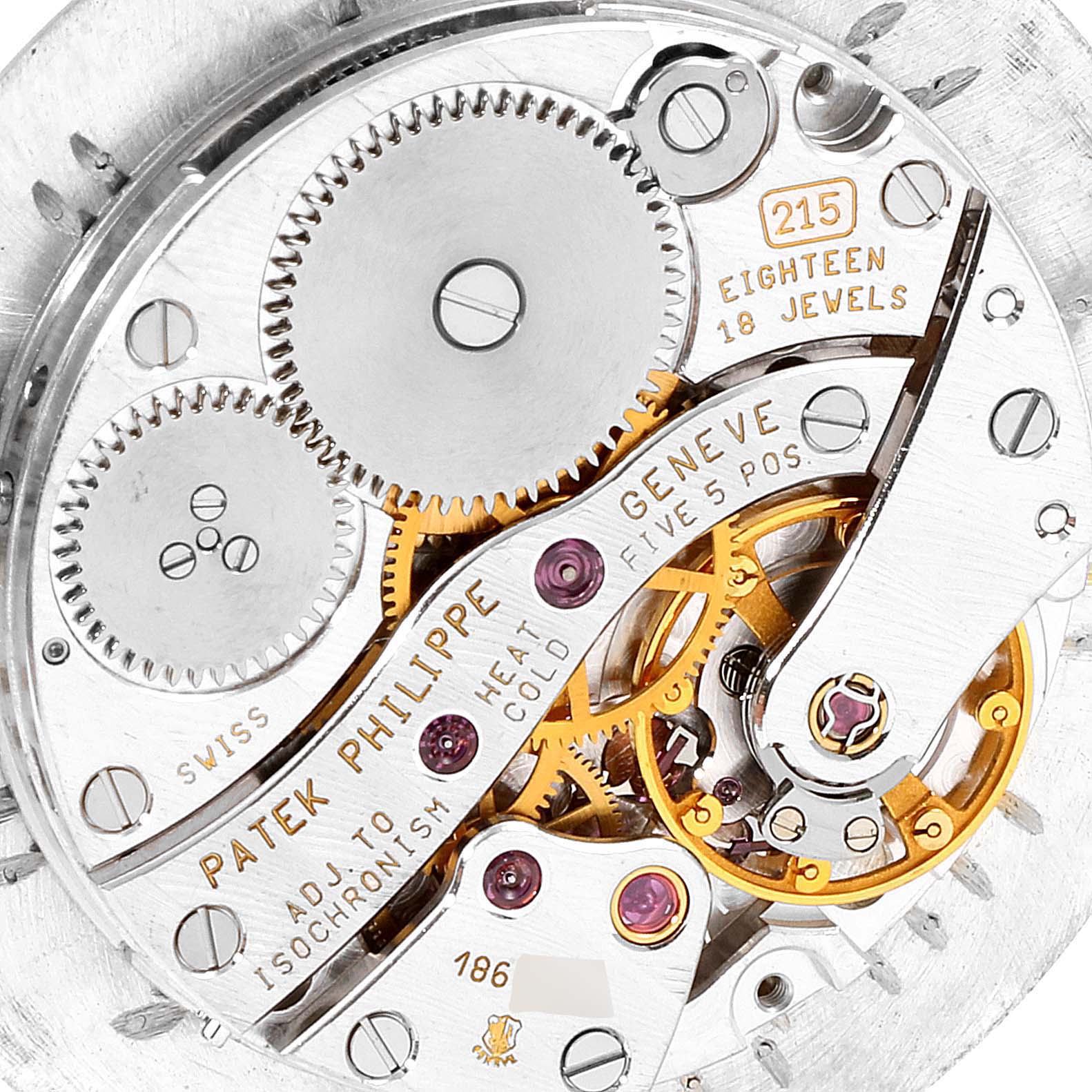 The image shows a close-up of the movement mechanism of a Patek Philippe Calatrava 5022R Men's Rose Gold Pink Dial 5022R Men's Rose Gold Pink Dial watch, highlighting gears and inscriptions.