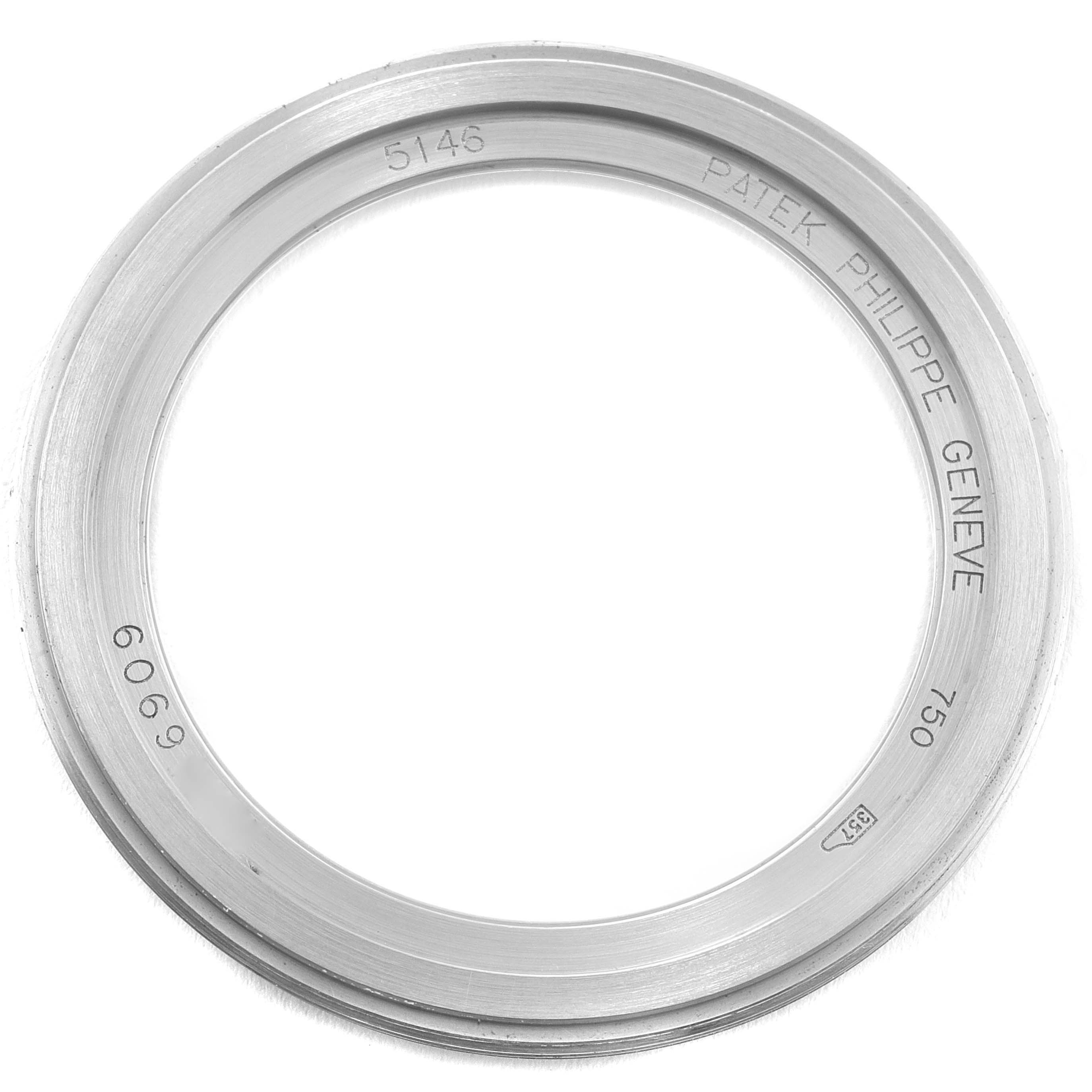 This image shows the bezel of the Patek Philippe 5146G Men's White Gold Grey Dial 5146G Men's White Gold Grey Dial Complicated Annual Calendar White Gold Men's Watch 5146, displaying engravings and markings.