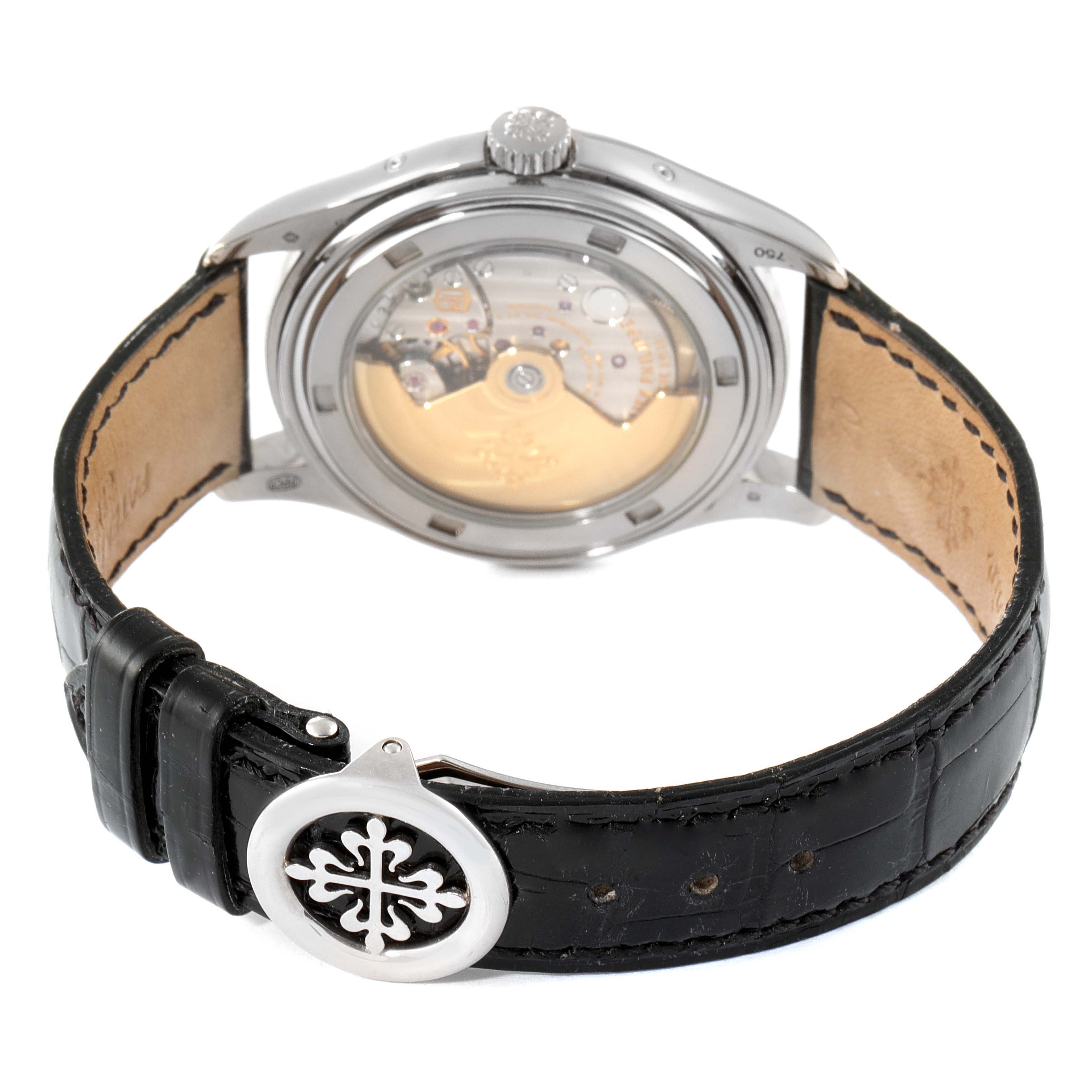 The image shows the back view of a Patek Philippe 5146G Men's White Gold Grey Dial 5146G Men's White Gold Grey Dial Complicated Annual Calendar White Gold Men's Watch 5146, highlighting its movement and leather strap.