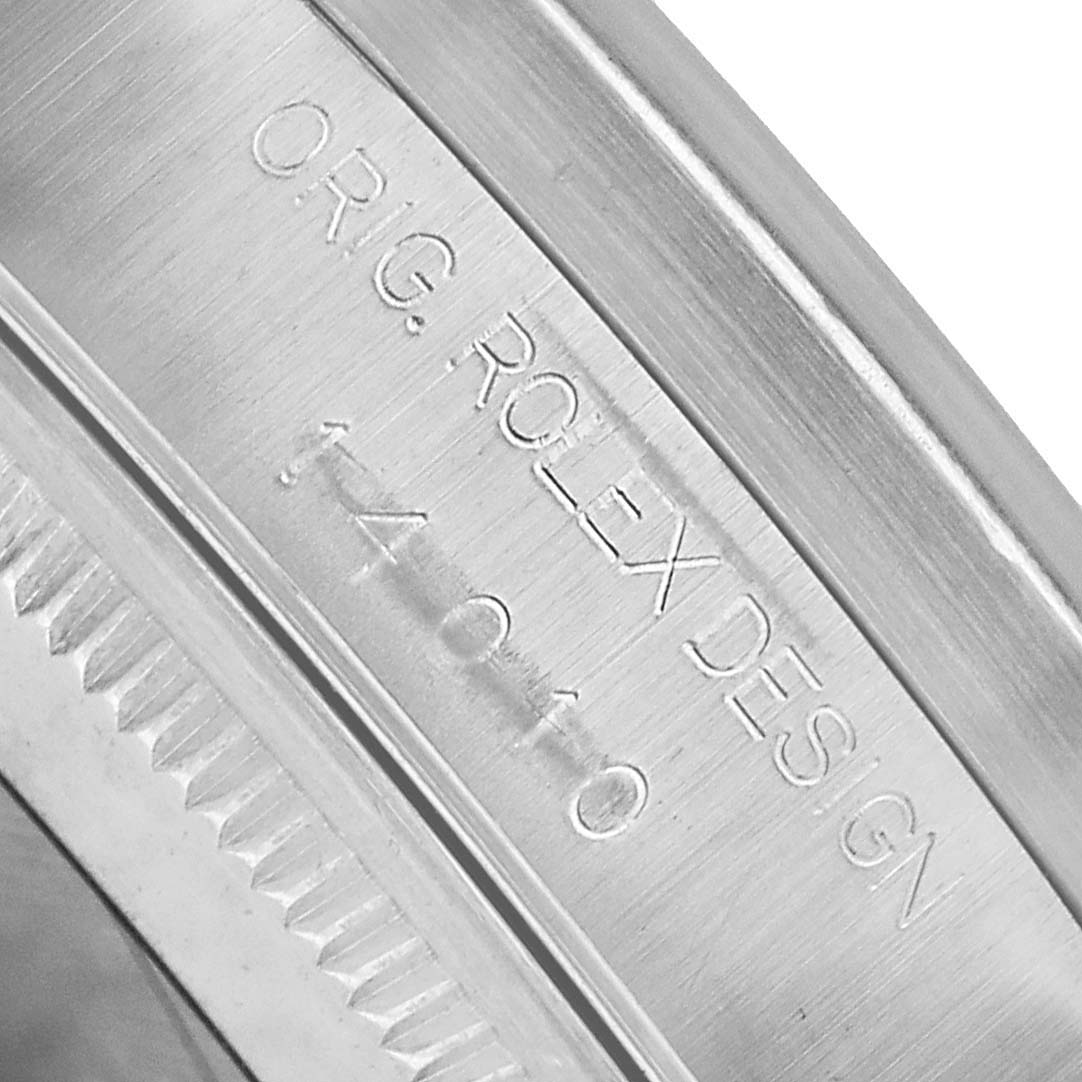 The image shows a close-up of the engraved edge of the bezel on a Rolex Air-King 14010M Men's Stainless Steel Silver Dial watch, highlighting the text "ORG. ROLEX DESIGN 14010".