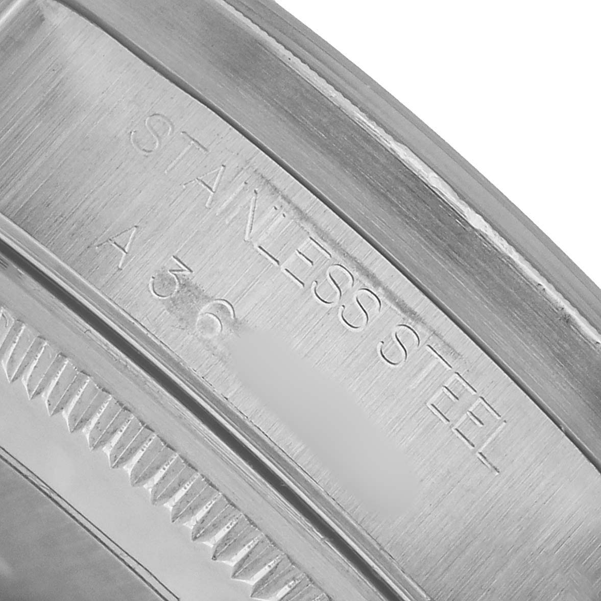 This image shows a close-up of the stainless steel case with engraved text on a Rolex Air-King 14010M Men's Stainless Steel Silver Dial watch.