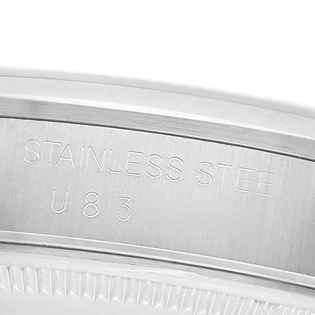 The image shows a close-up of the engraved stainless steel case of a Rolex Air-King 14000 Men's Stainless Steel Pink Dial watch.