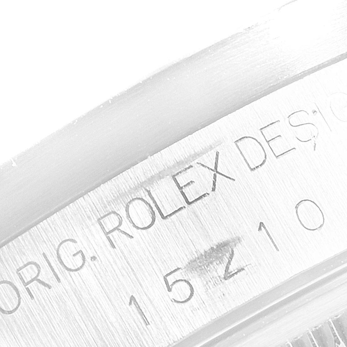 This image shows a close-up of the engraving on the side of the case of a Rolex Date 15200 Men's Stainless Steel White Dial 15200 Men's Stainless Steel White Dial model watch.
