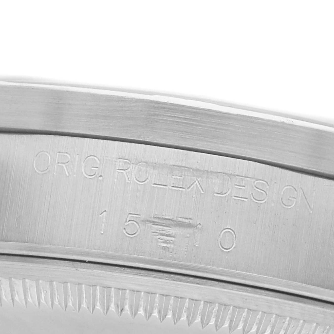 The image shows a close-up of the watch case's inner rim, displaying the "Rolex Date 15210 Men's Stainless Steel Black Dial" model engravings.