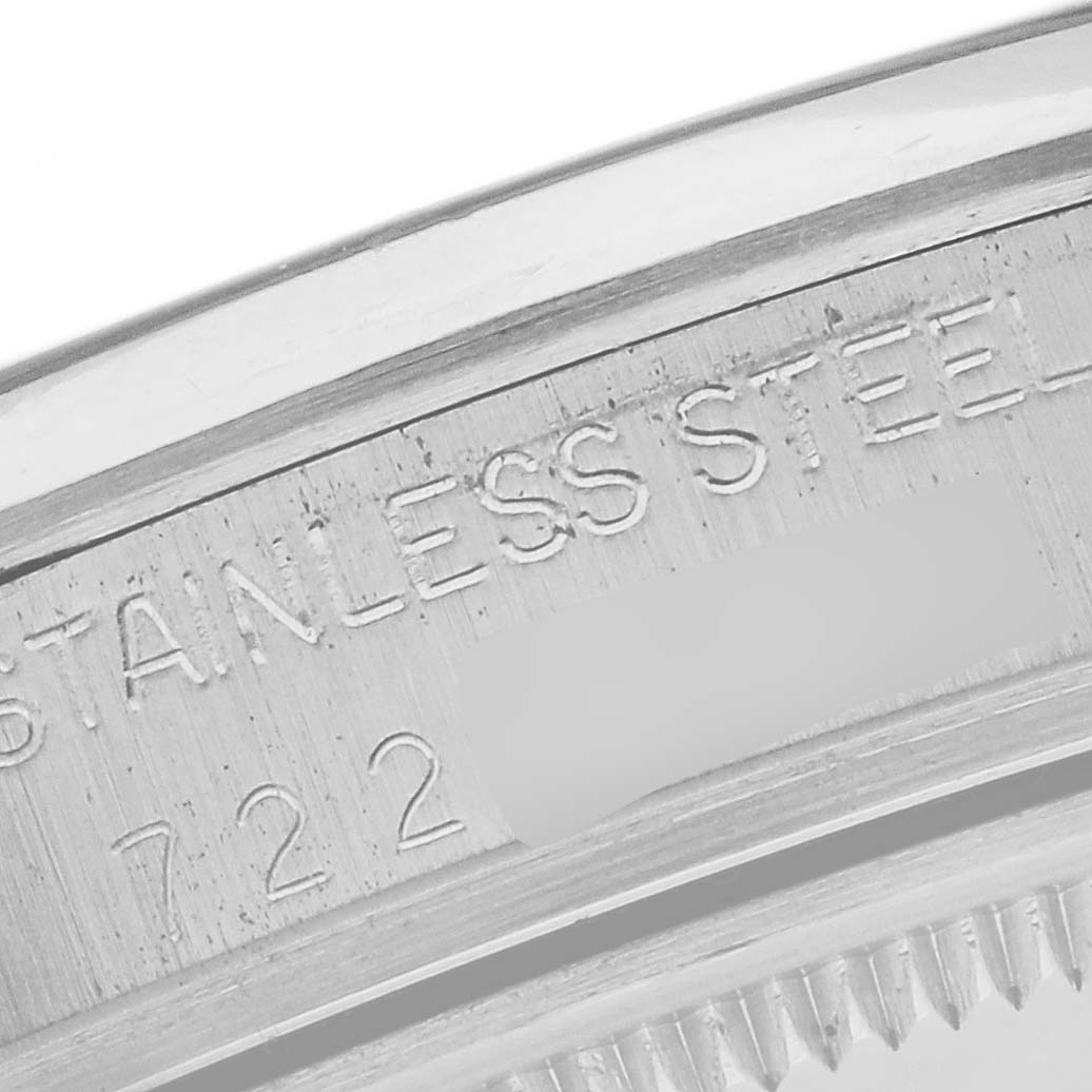 The image shows a close-up of the stainless steel casing with engravings on the Rolex Date 15000 Men's Stainless Steel Silver Dial 15000 Men's Stainless Steel Silver Dial watch.
