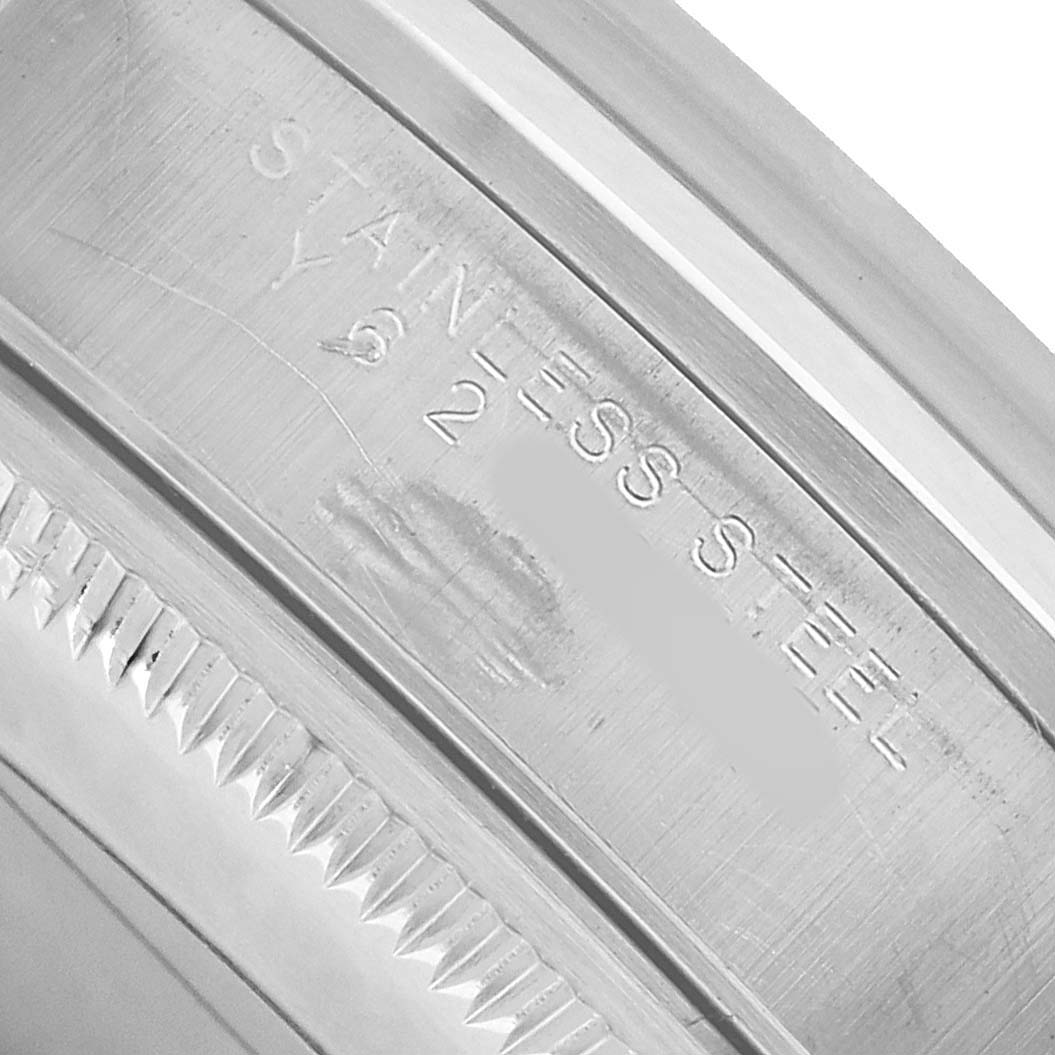 The image shows a close-up of the stainless steel case side of a Rolex Date 15200 Men's Stainless Steel Pink Dial model.