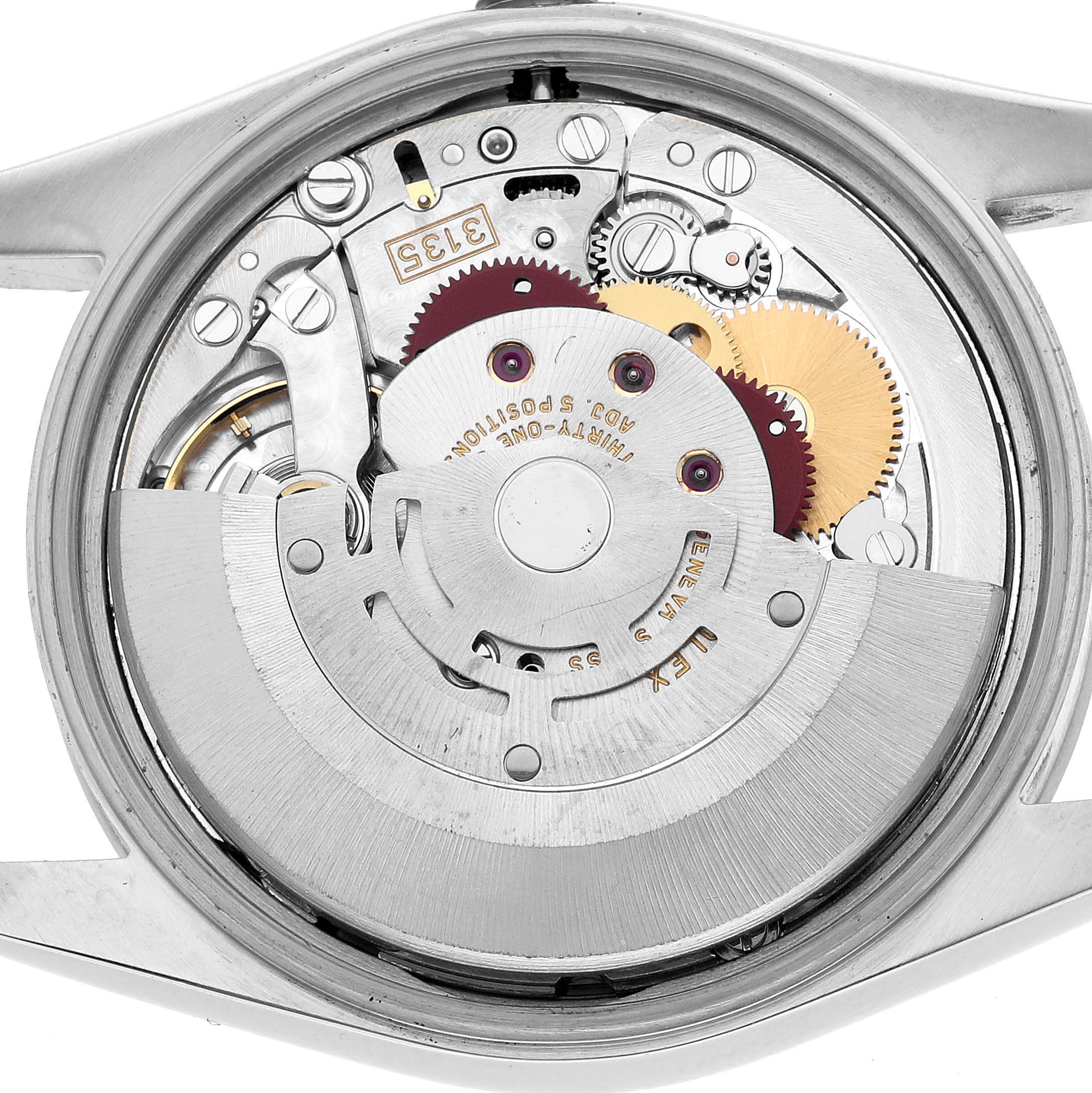 The image shows a top-down view of the movement inside a Rolex Date 15200 Men's Stainless Steel Pink Dial watch, highlighting gears and components.