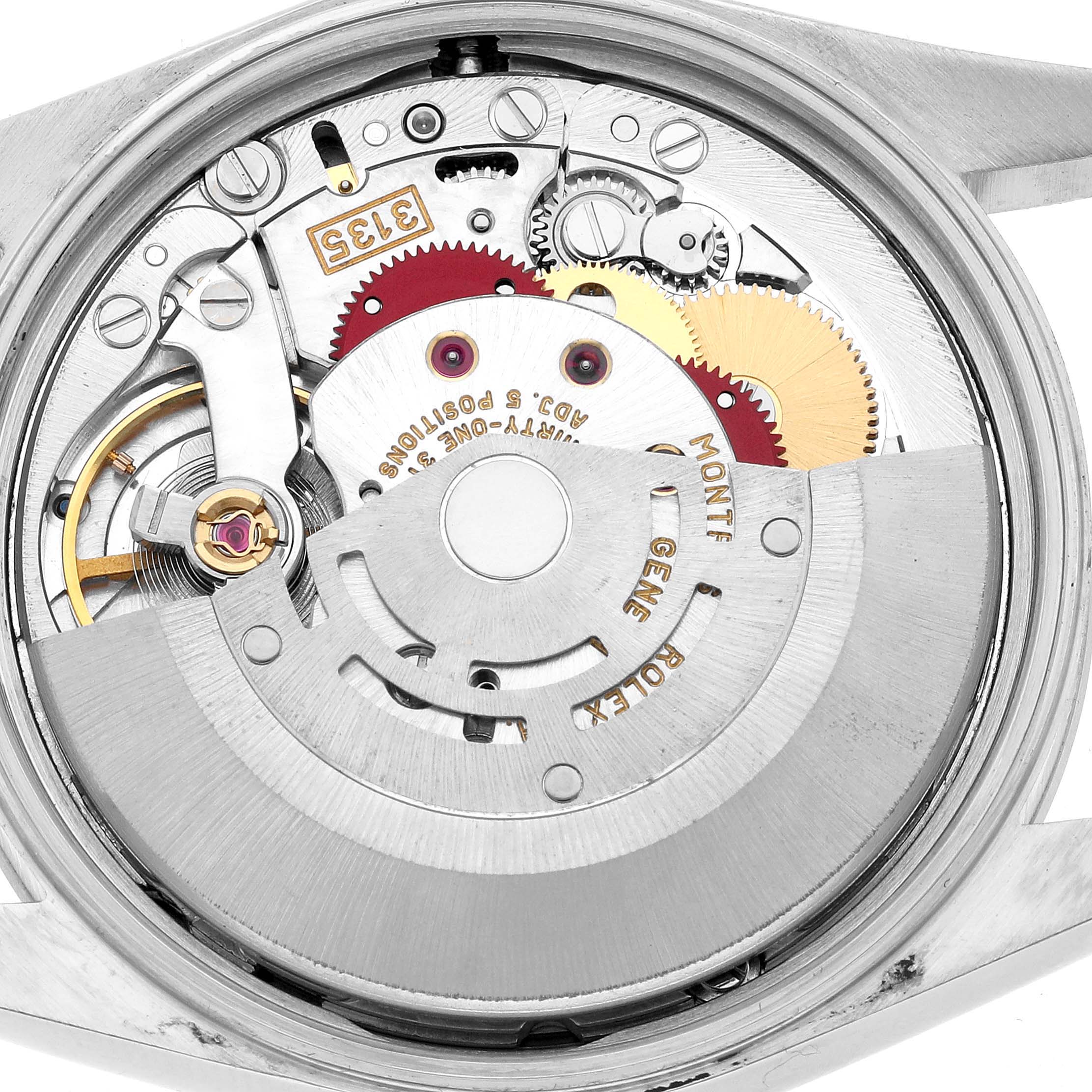 The image shows the backside internals of a Rolex Date 15200 Men's Stainless Steel White Dial model, highlighting the movement and gears.
