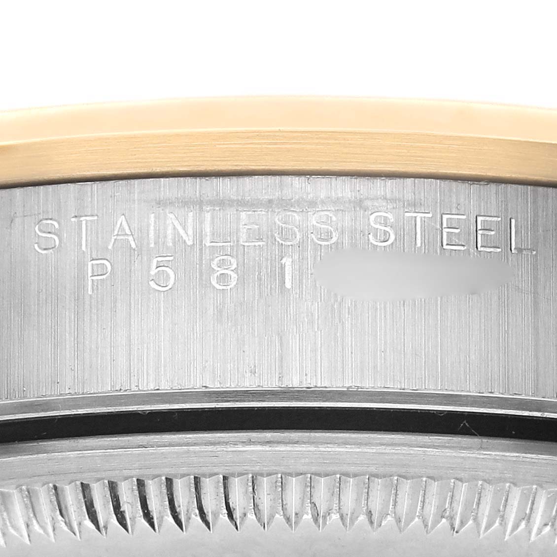 The image shows a close-up of the Rolex Date 15203 Men's Steel and Gold (two tone) Grey Dial 15203 Men's Steel and Gold (two tone) Grey Dial's case side, highlighting the stainless steel marking.