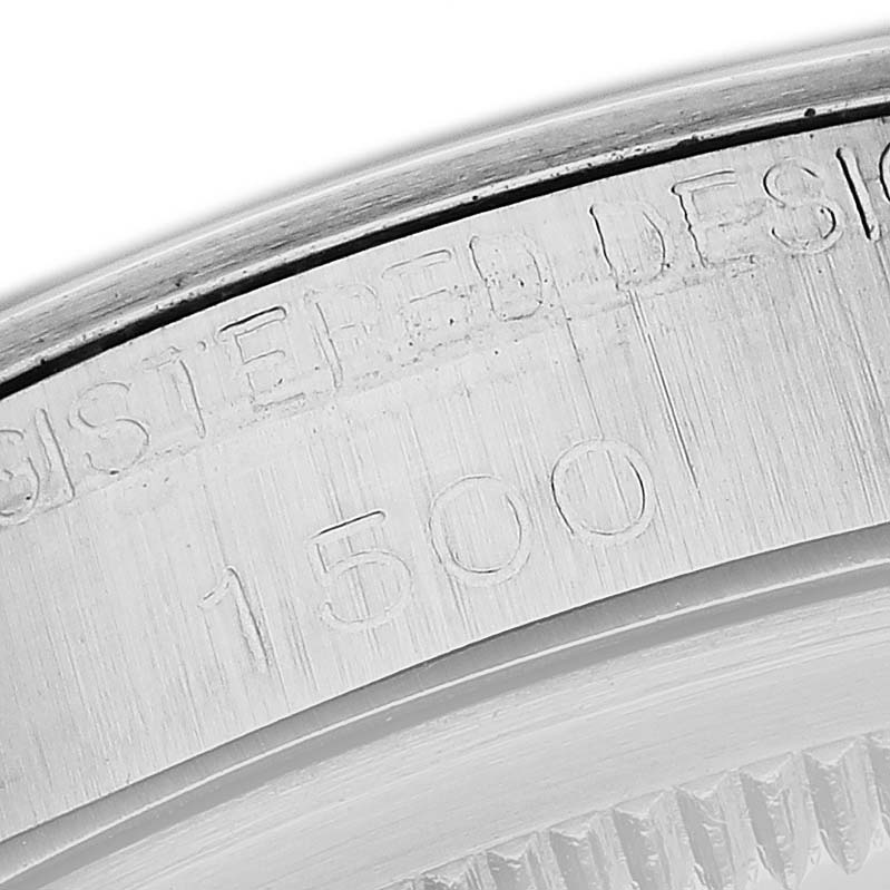 The image shows the engraved model and serial number on the inner bezel of a Rolex Date 66579 Men's Stainless Steel White Dial 66579 Men's Stainless Steel White Dial watch.