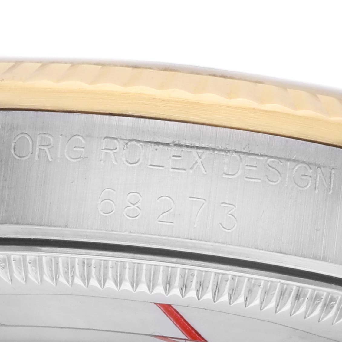The image shows a close-up of the side of a Mid-Size Rolex watch, highlighting the serial number and design engraving.