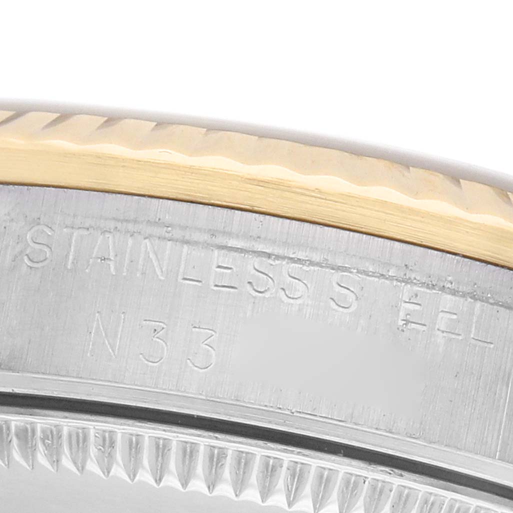 The image shows a close-up of the side of a Rolex Mid-Size 68273 Women's Steel and Gold (two tone) Champagne Dial watch, highlighting the stainless steel bezel engraving.