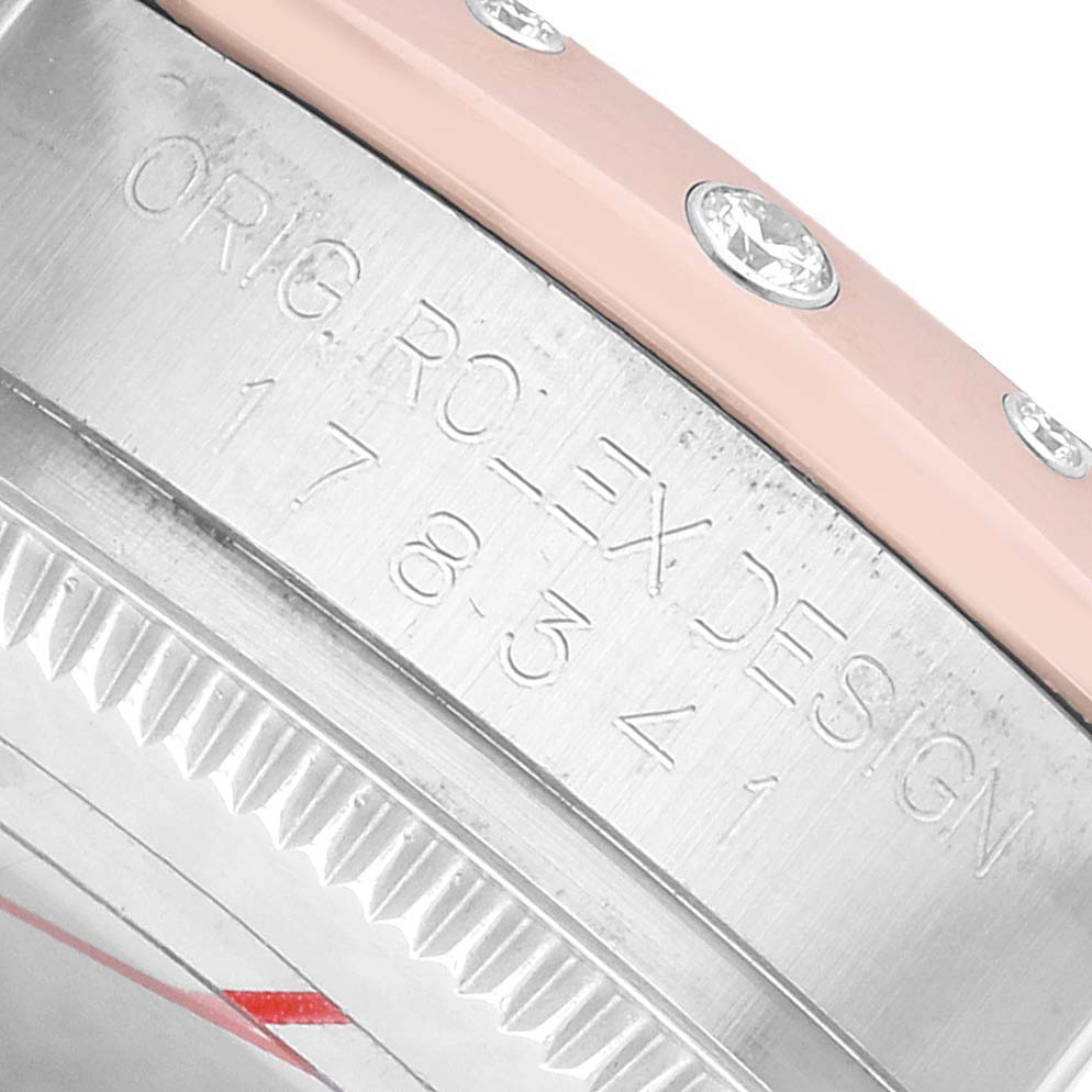 The image shows a close-up angle of the Rolex Mid-Size 178341 Women's Steel and Gold (two tone) Brown Dial watch case, focusing on the engraved bezel and gem-set edge.