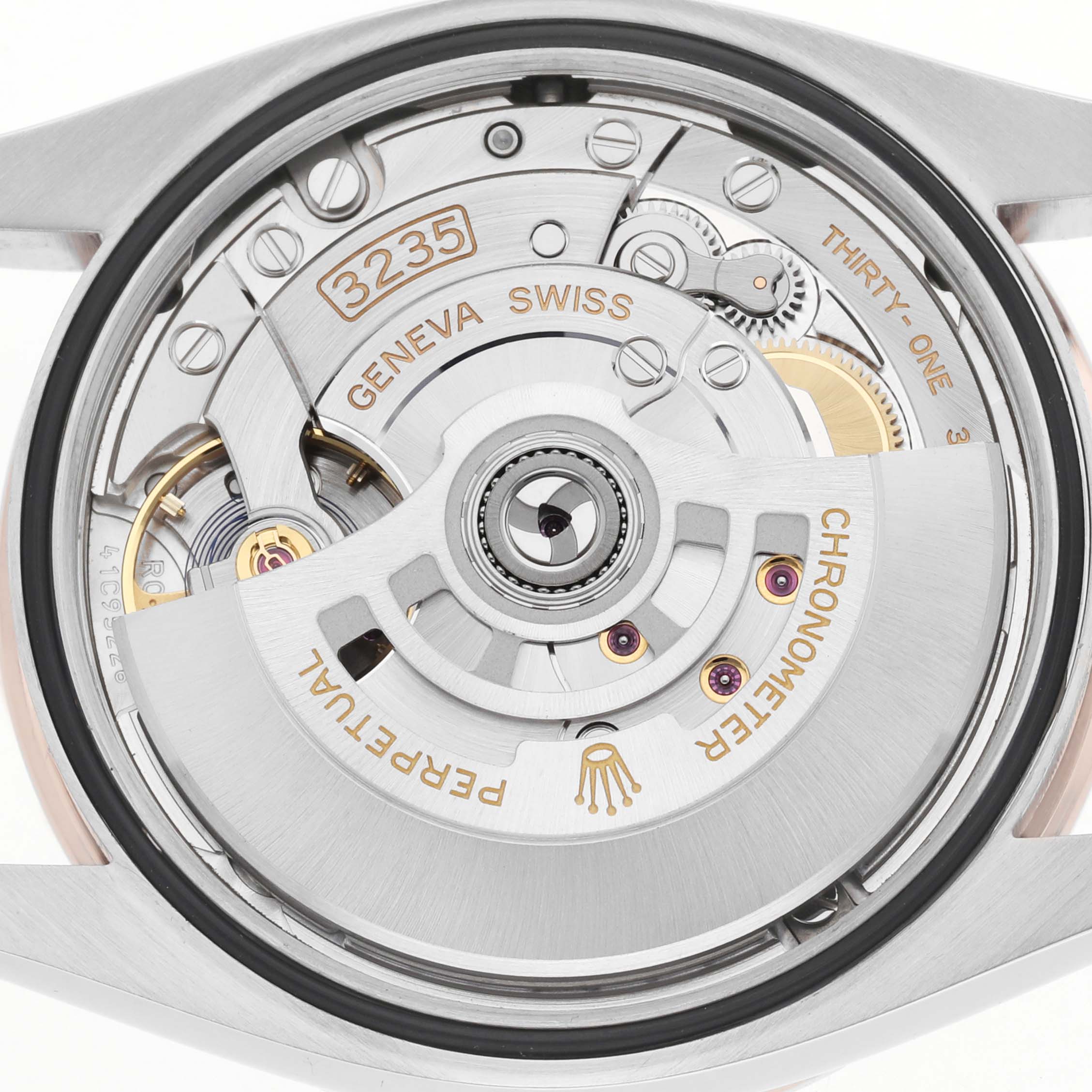 The image shows the Rolex Datejust 126281 Men's Steel and Gold (two tone) White Dial movement from a back angle, highlighting the rotor and intricate mechanics.