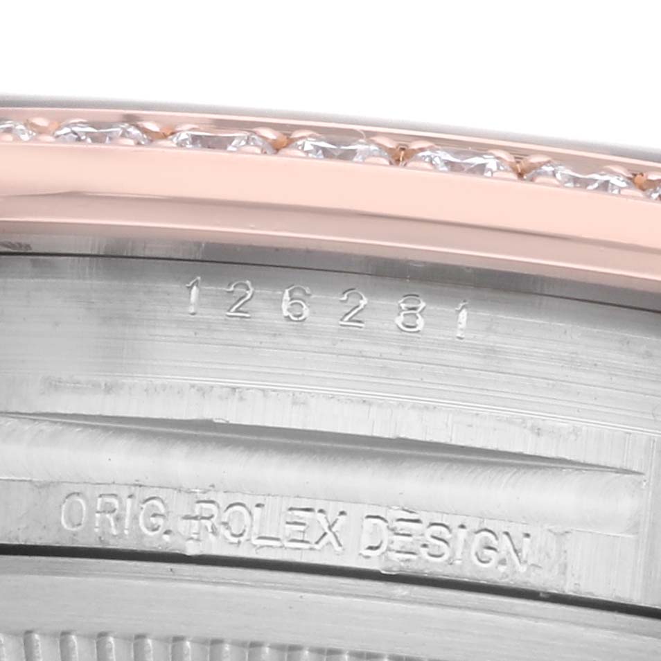 The image shows a close-up of the Rolex Datejust 126281 Men's Steel and Gold (two tone) White Dial model's bezel with diamonds and engraved inner ring details.